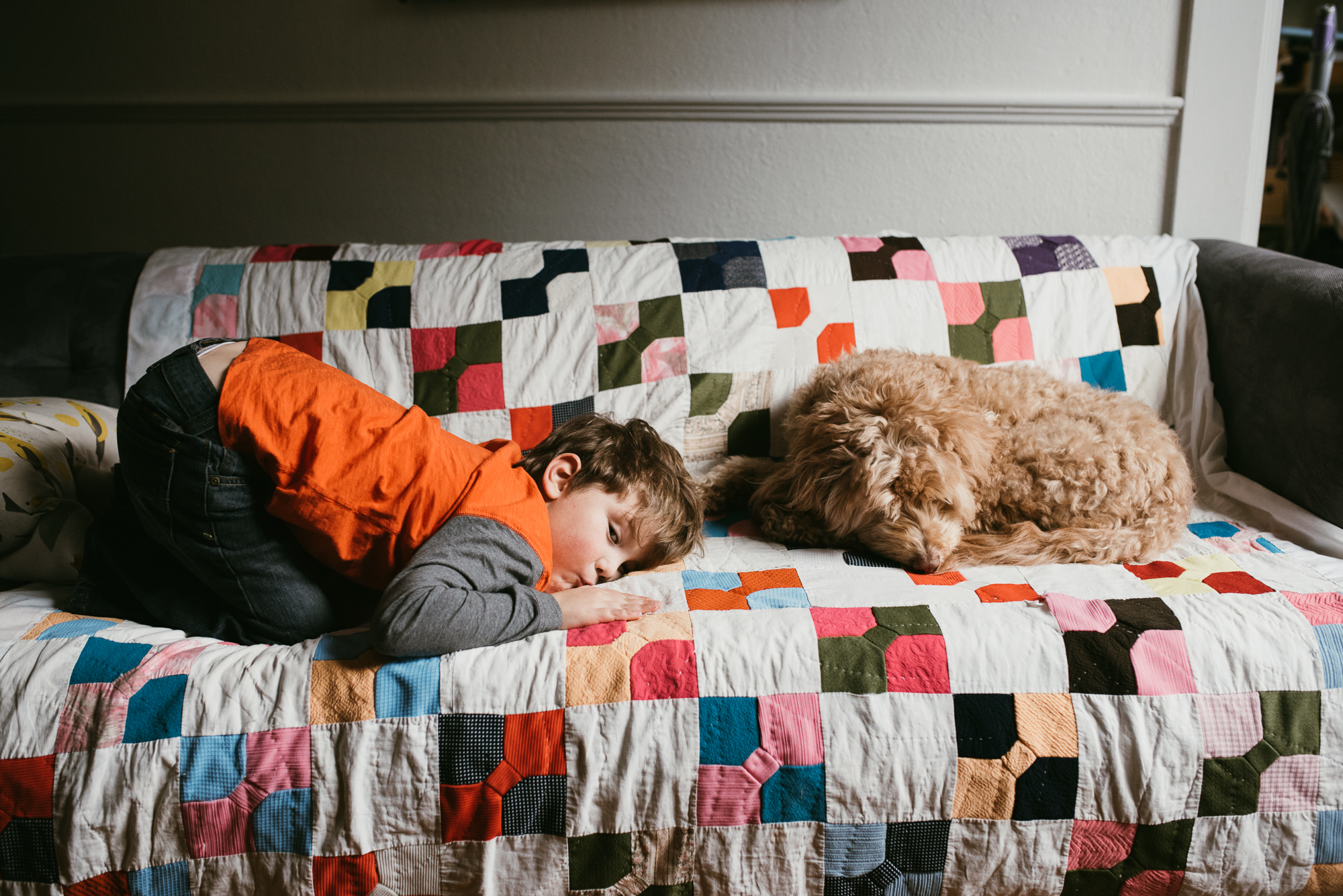 boy asleep on couch with dog - documentary family photography