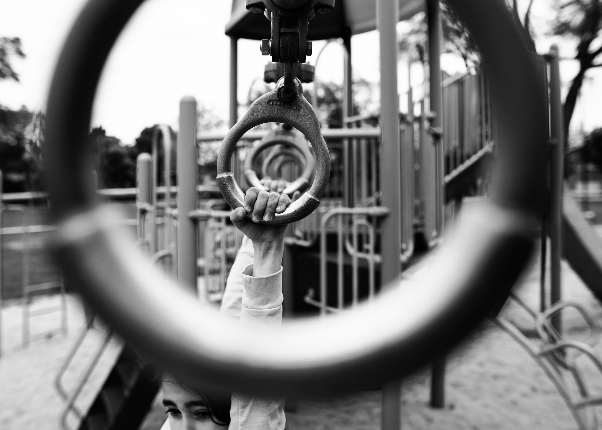 child plays on rings - Documentary Family Photography