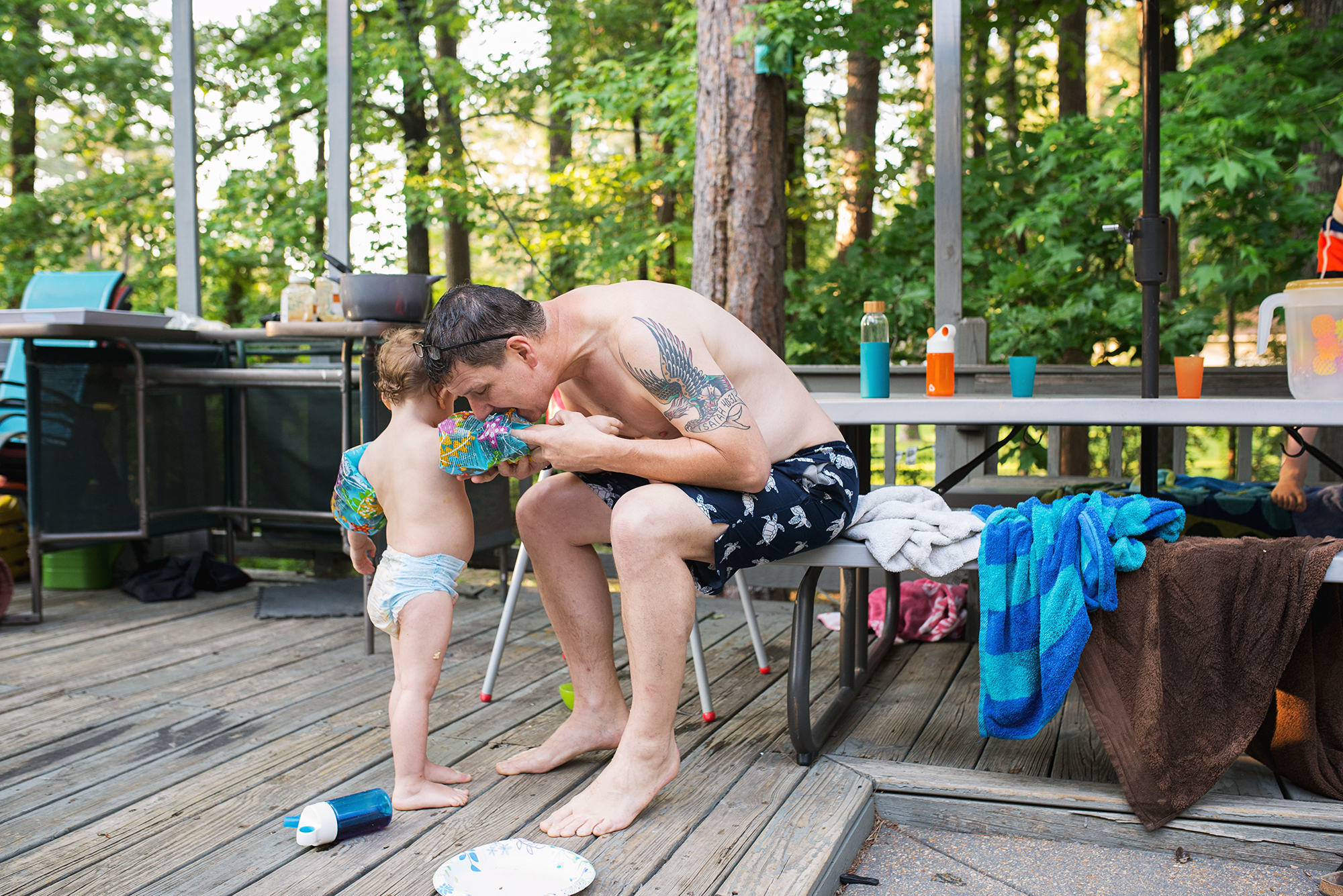 man blows up boys water wings - documentary family photography