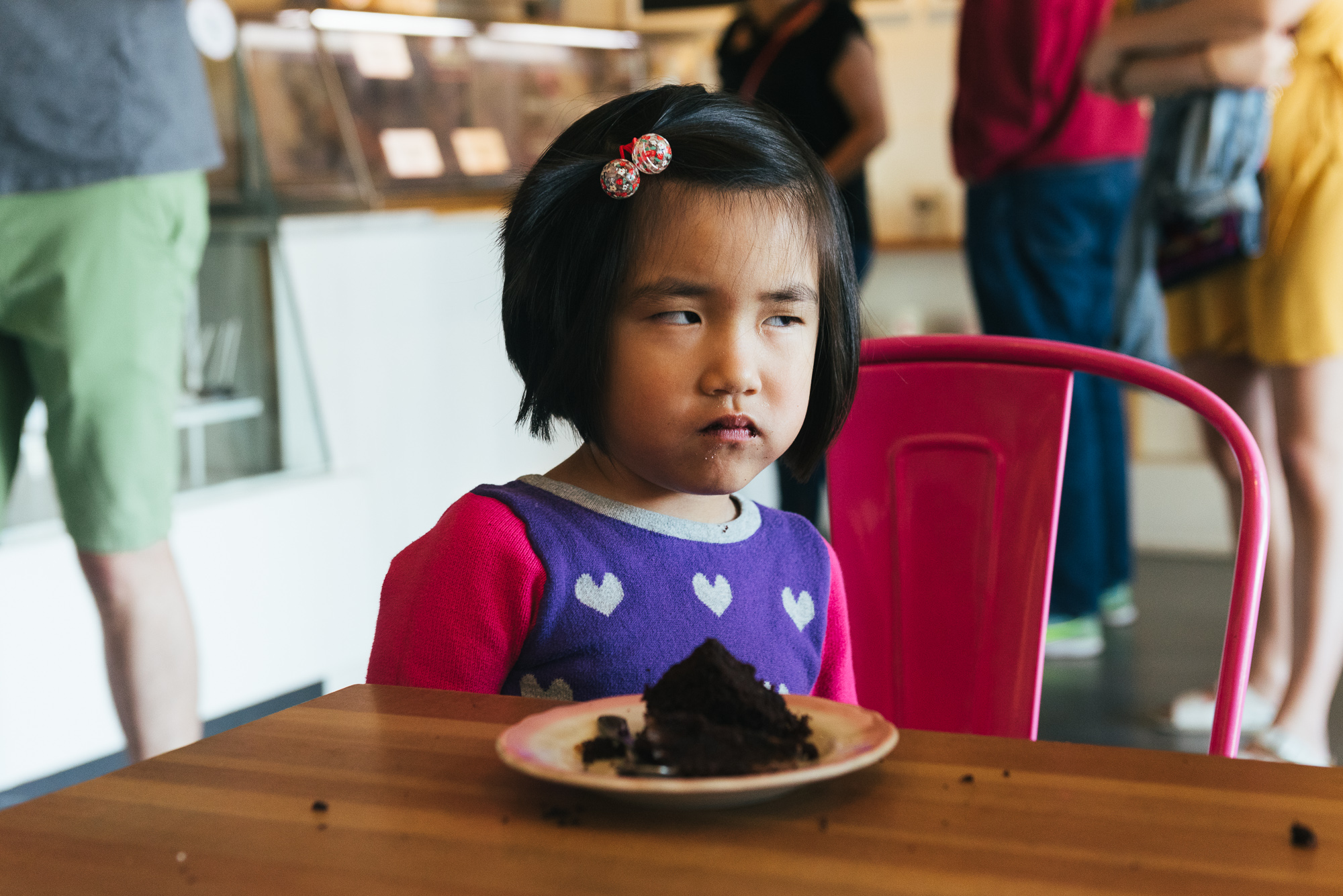 girl gives side eye at bakery - documentary family photography
