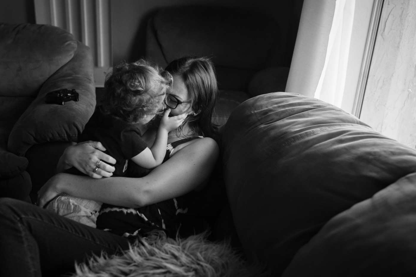 mom snuggling with child - documentary family photography