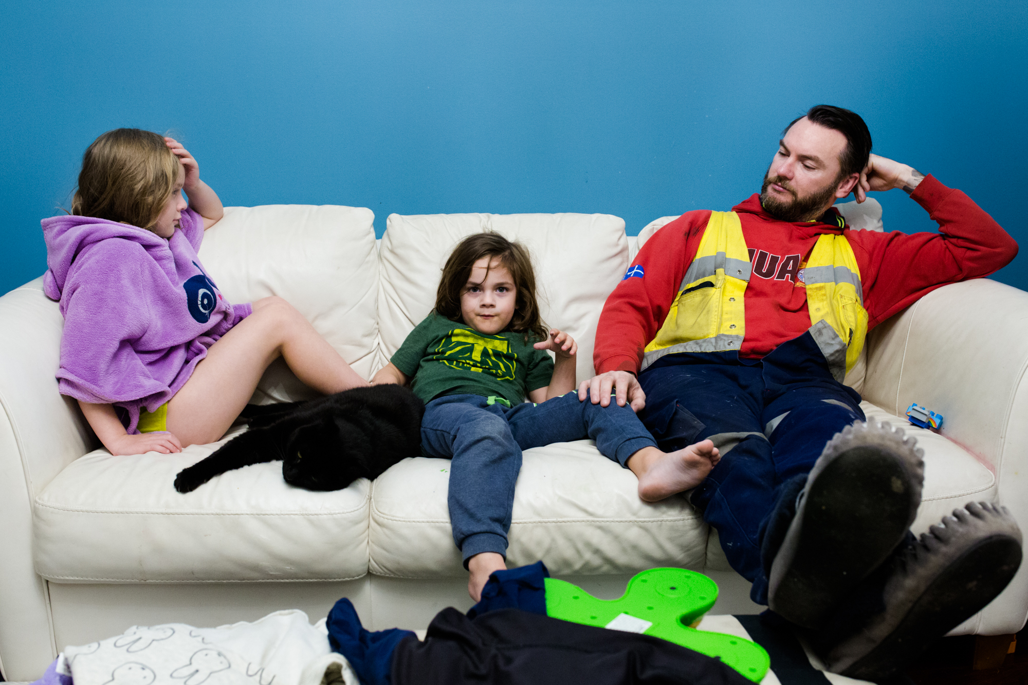 man with kids on couch- Documentary family photography