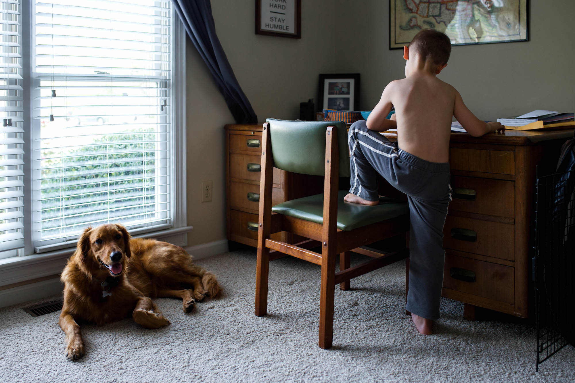 boy works at desk - Documentary family photography