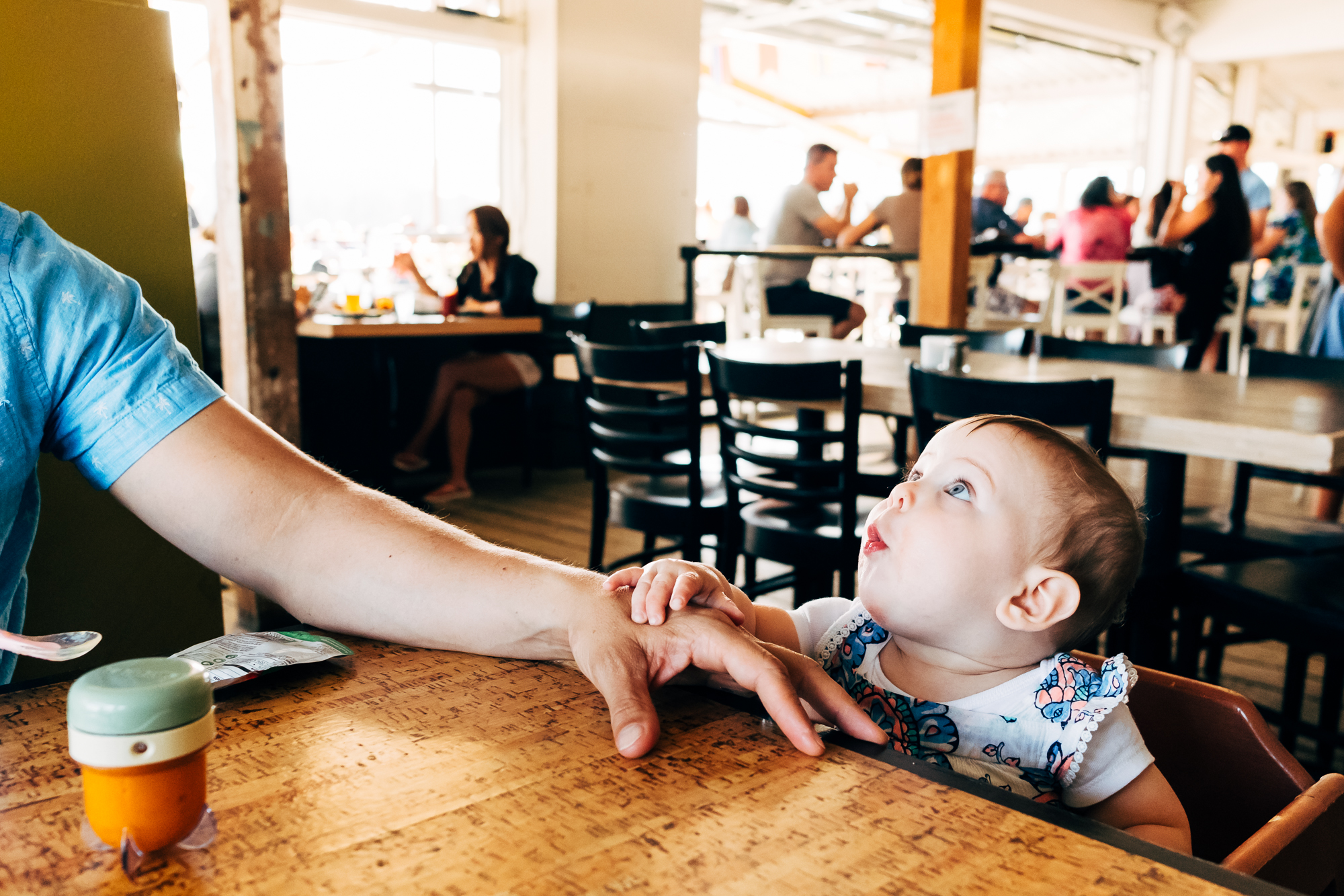 baby makes face at restaurant - Documentary family photography