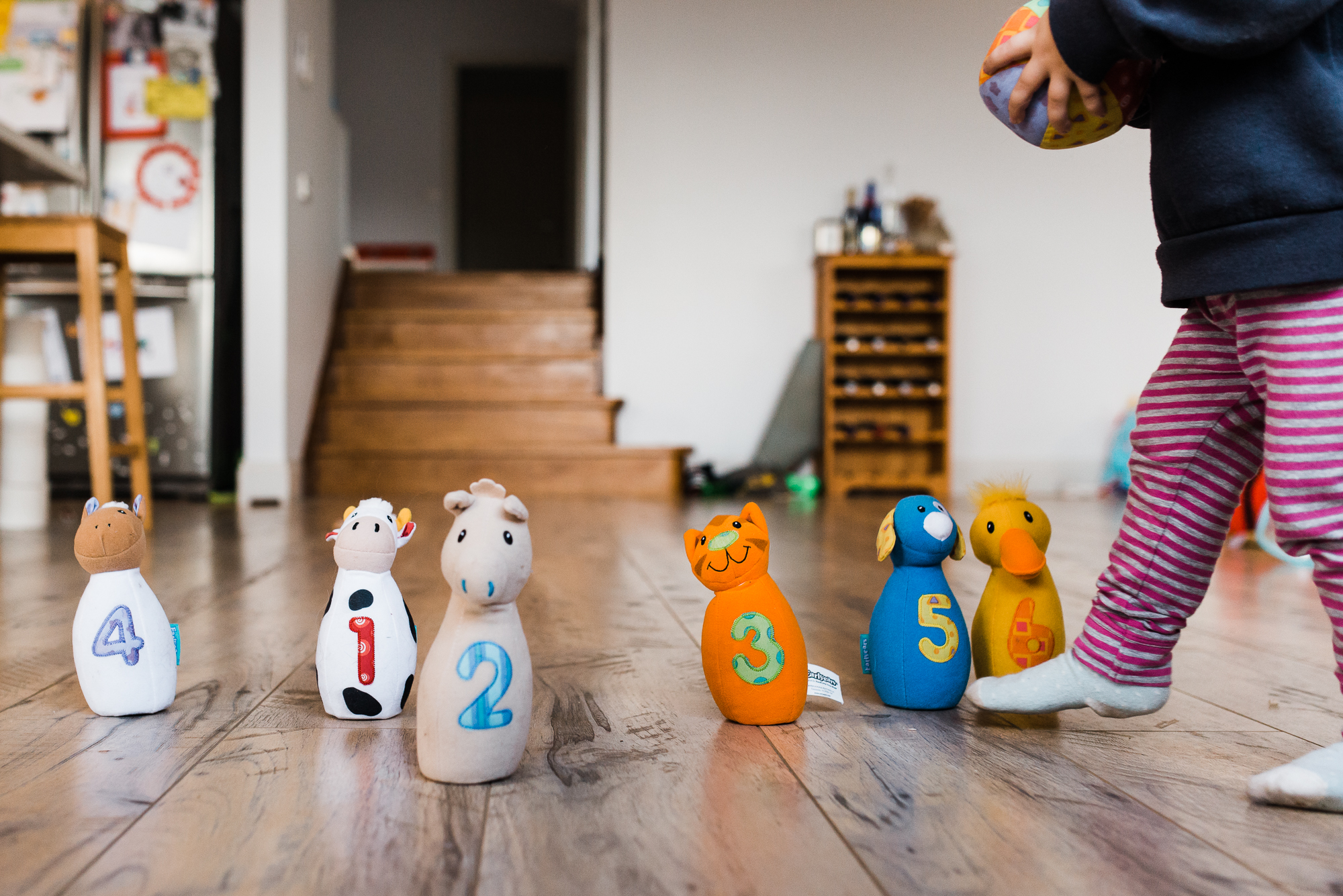 child with bowling toys - Documentary family photography