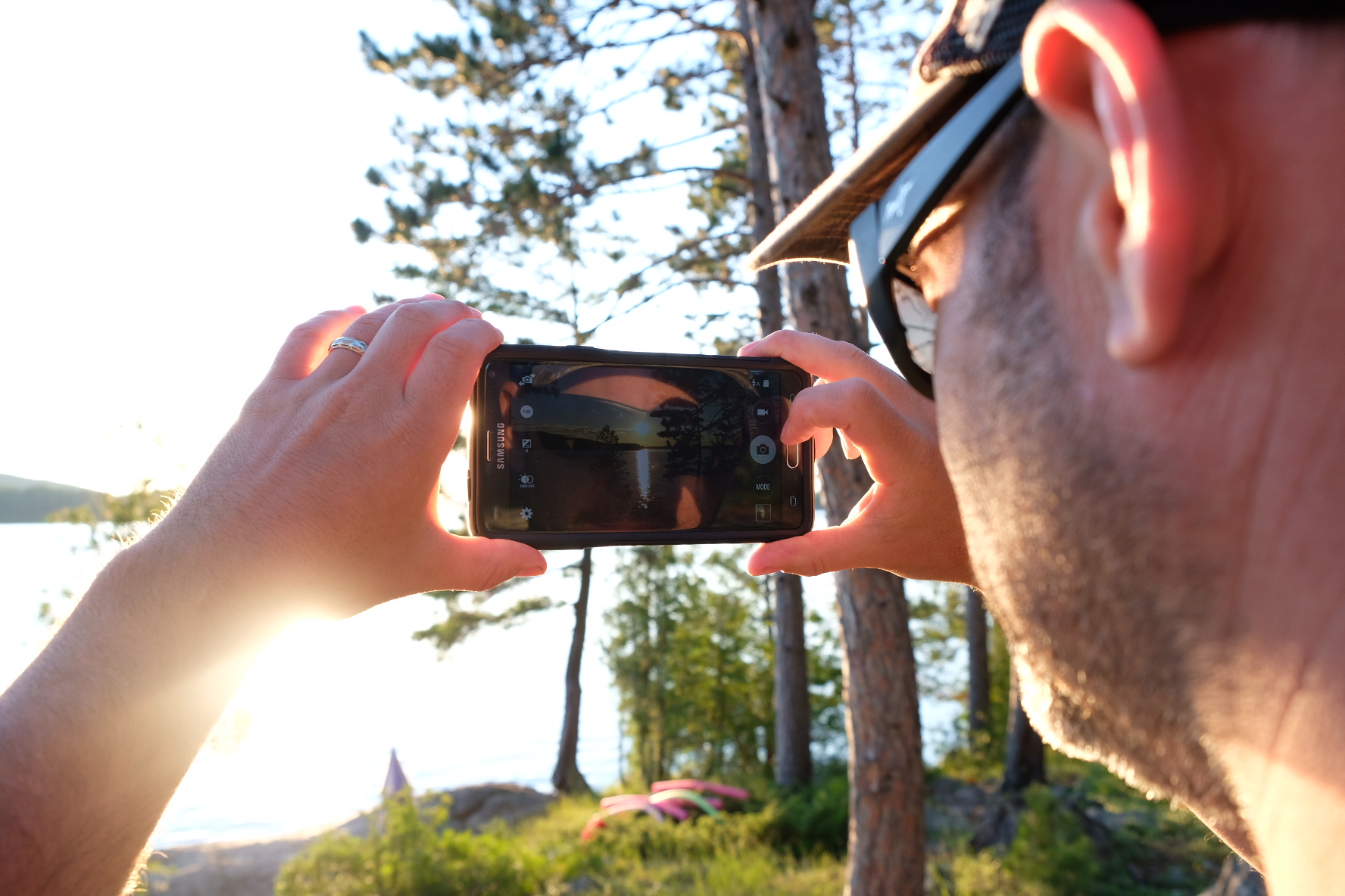 man takes photo with iphone - Documentary Family Photography