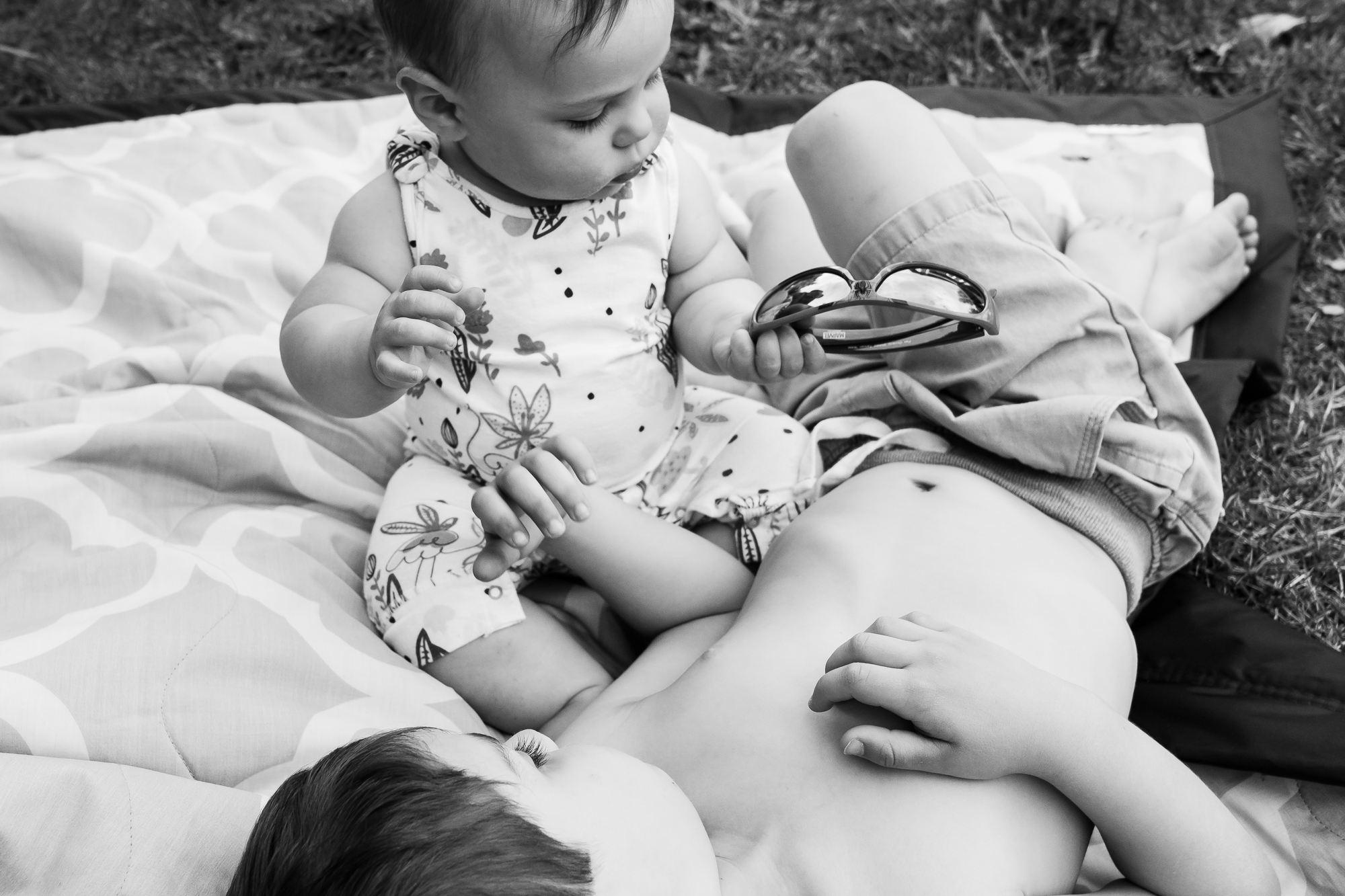 kids lounge on blanket in grass - Documentary Family Photography