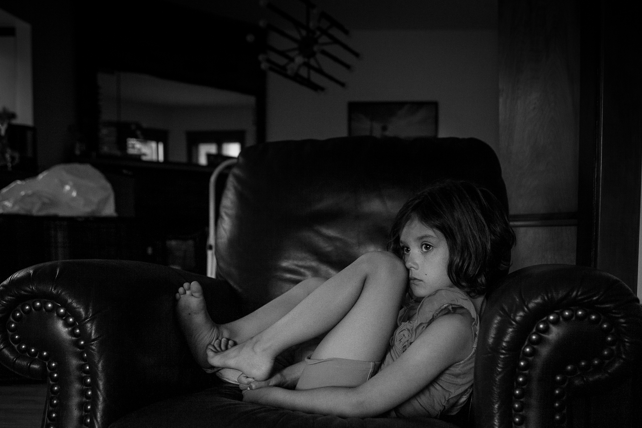 girl curled up in chair - Documentary Family Photography