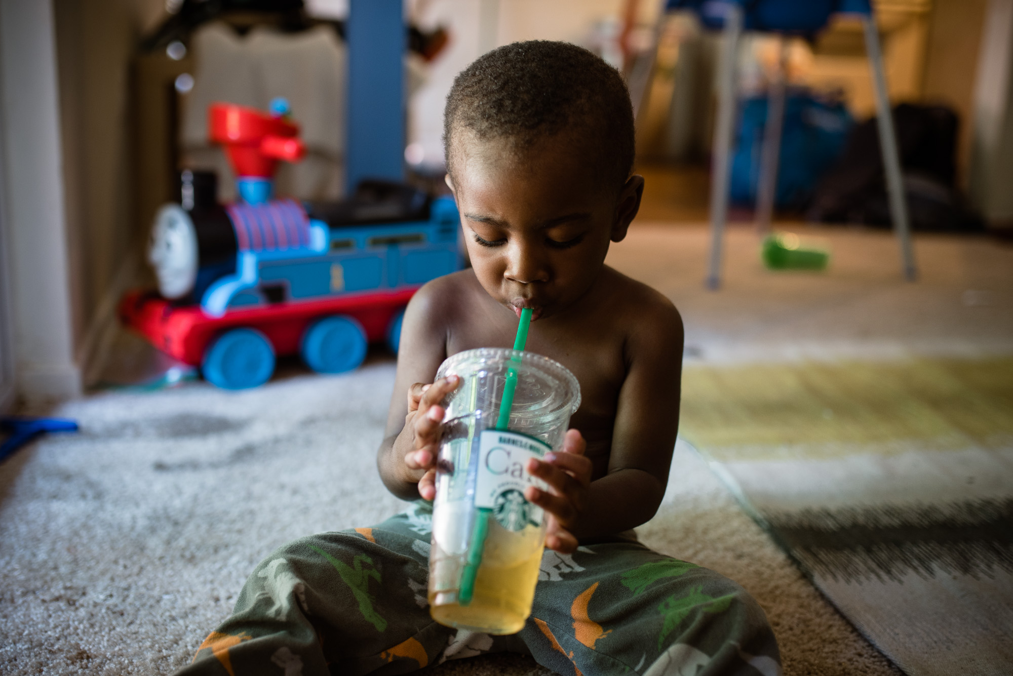 boy drinks tea from to go cup -Documentary Family Photography