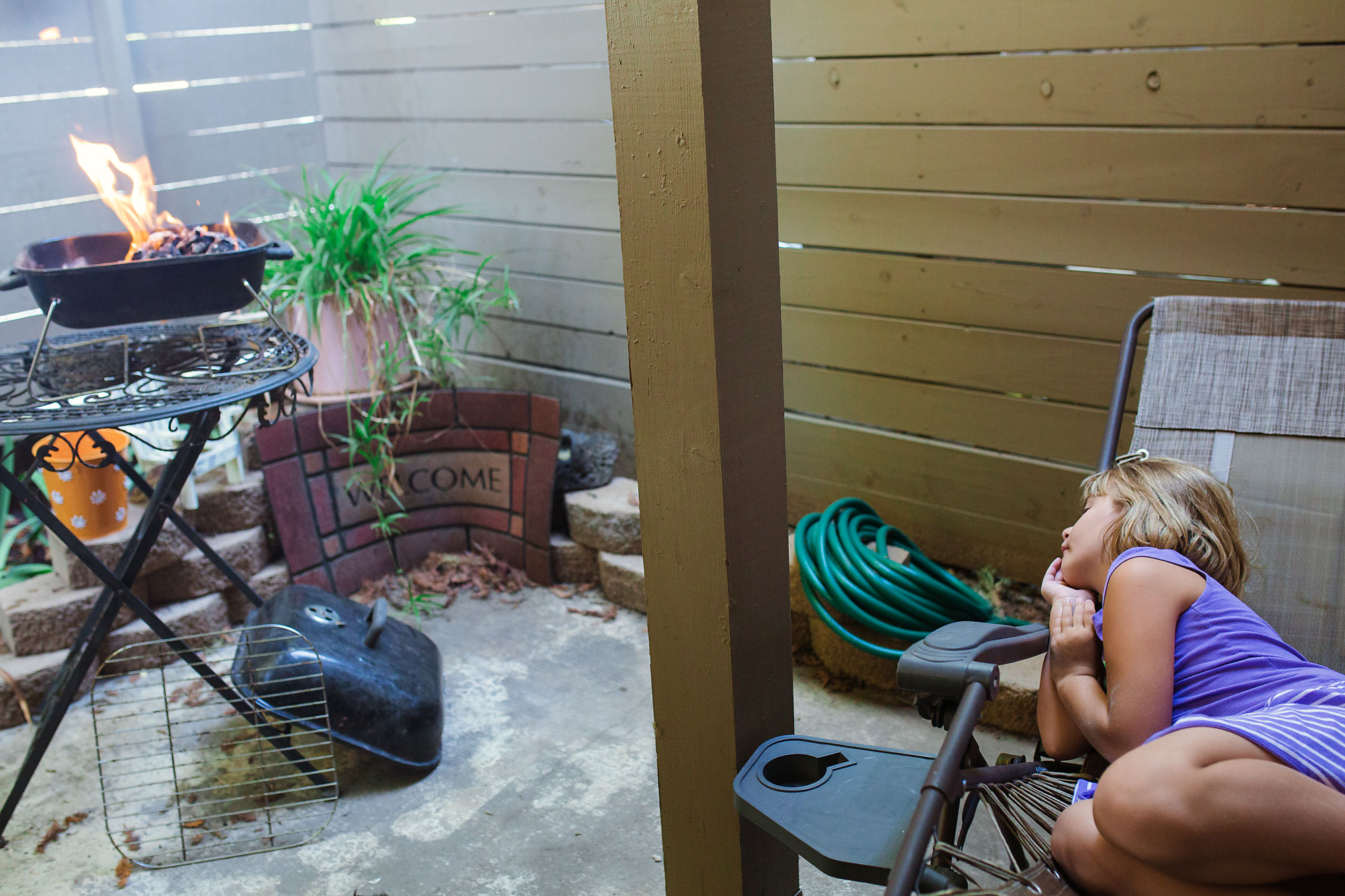 girl watches grill - Documentary Family Photography