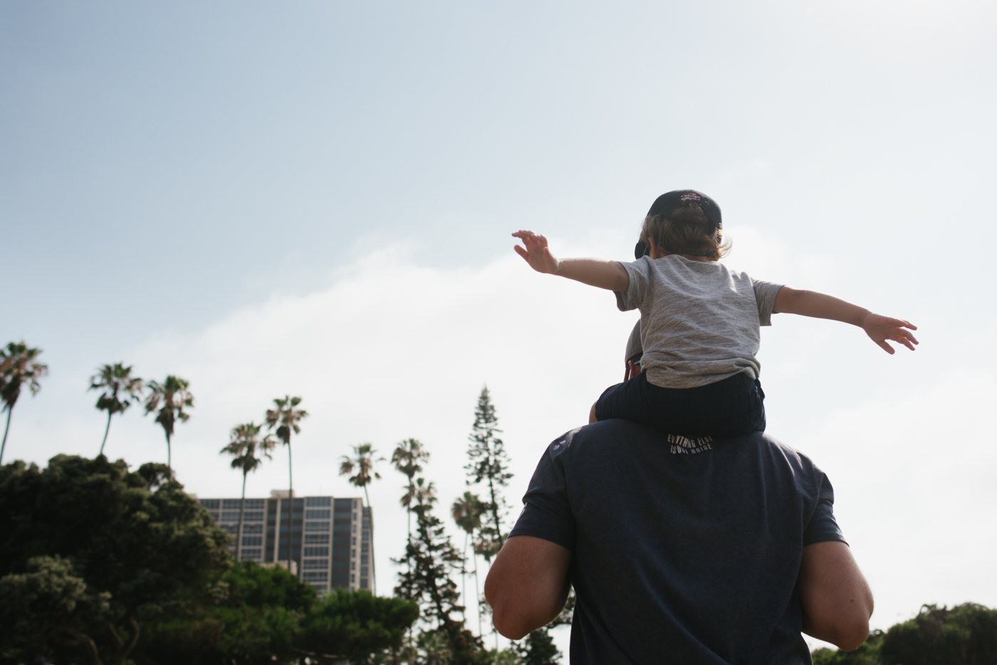 boy on father's shoulders - Documentary Family Photography