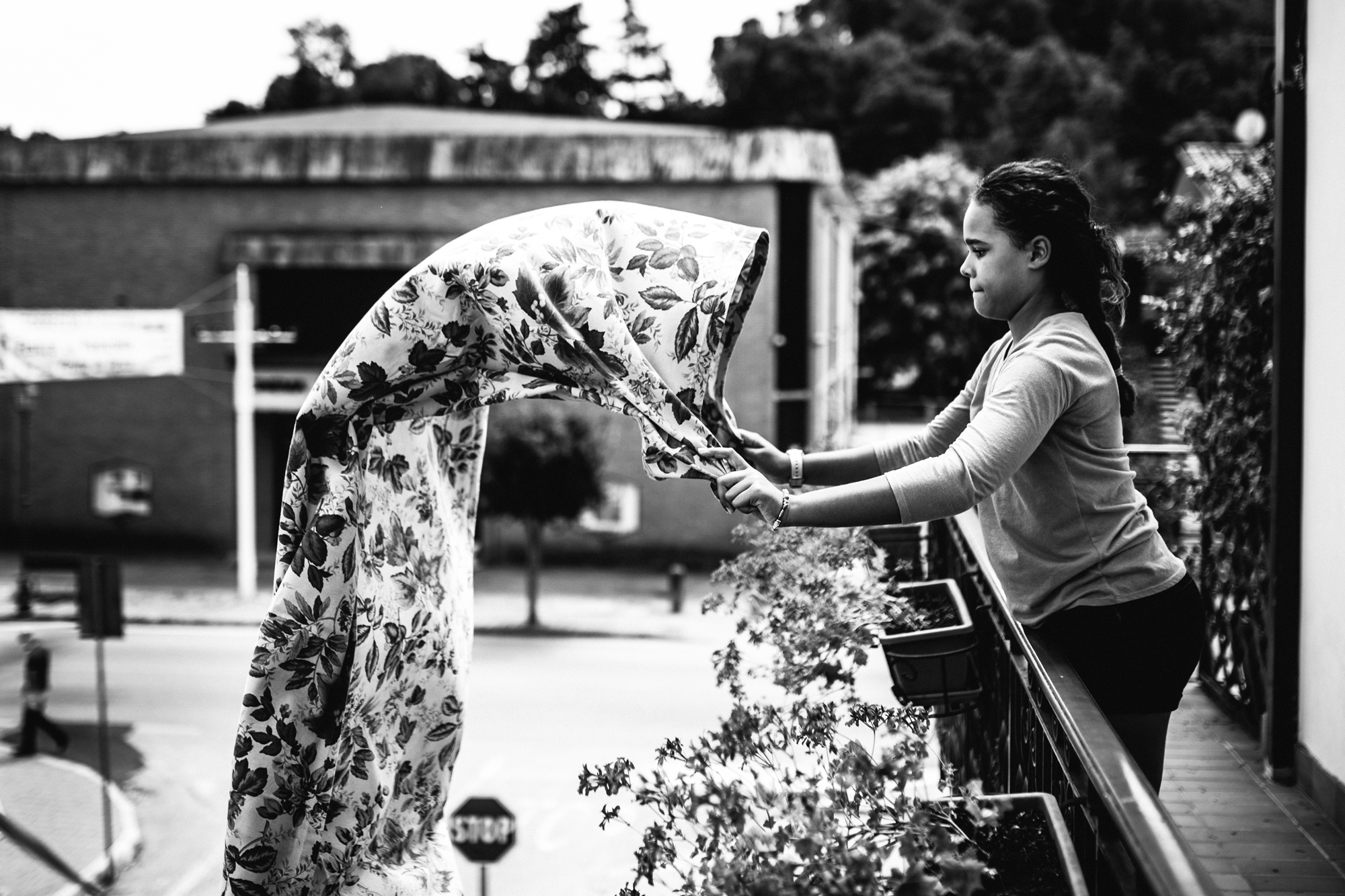 girl shakes out tablecloth - Documentary Family Photography