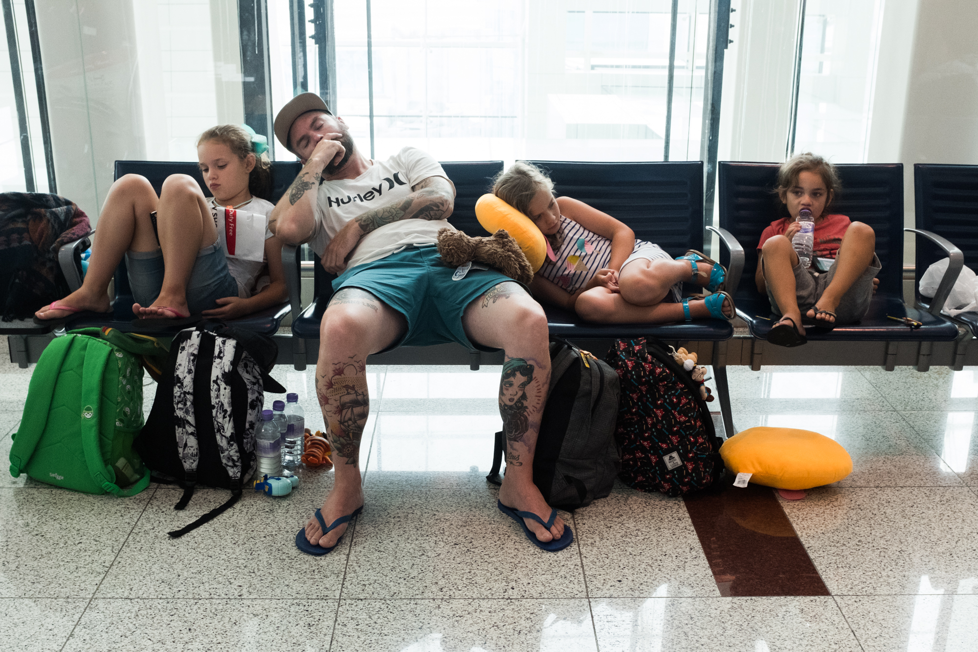 Family Sitting At Airport - Documentary Family Photography