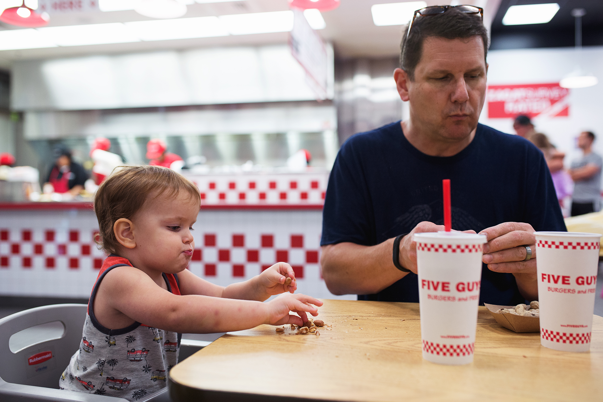 father and child at burger restaurant - documentary family photography