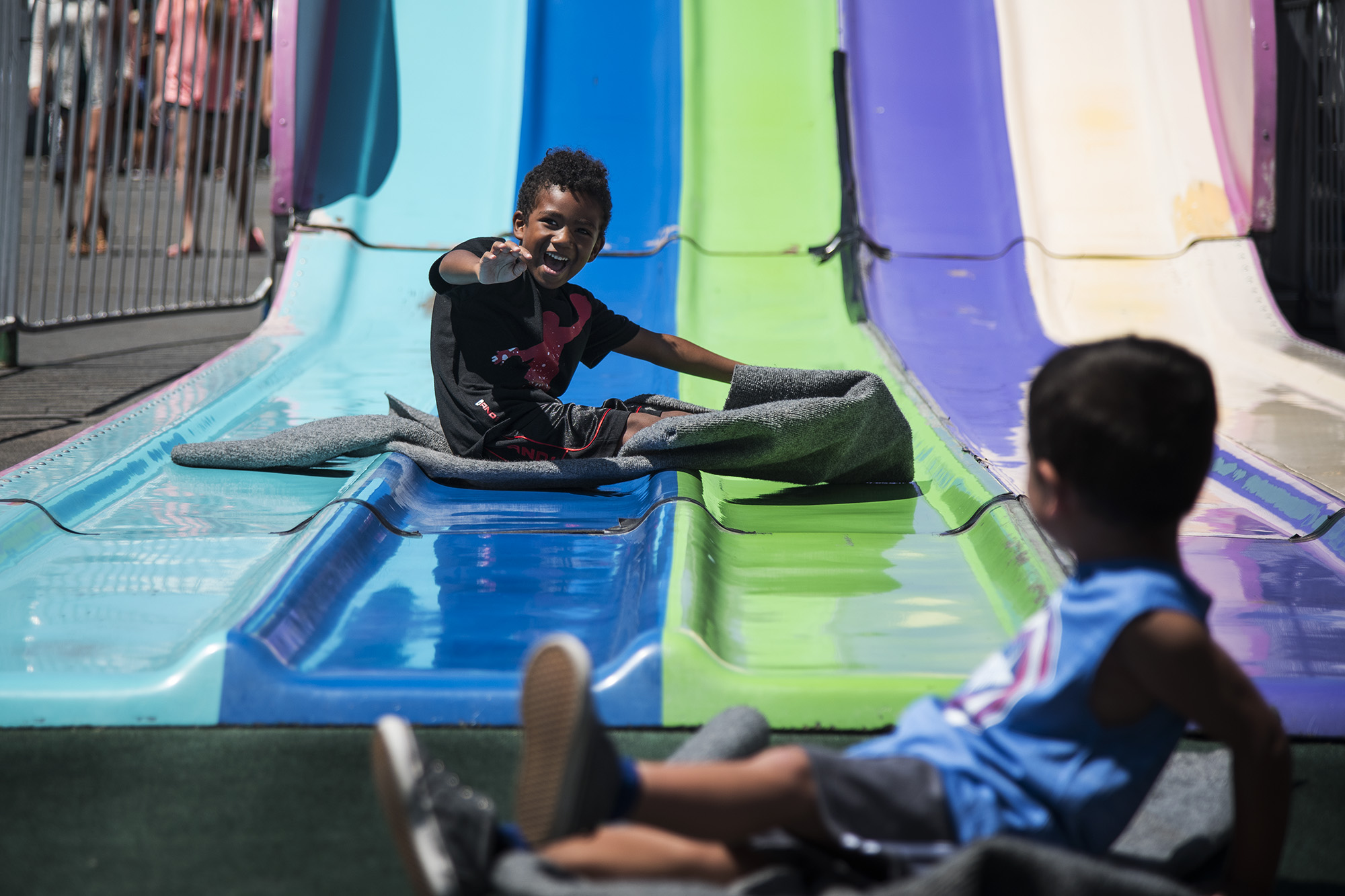 boy on slide - documentary family photography