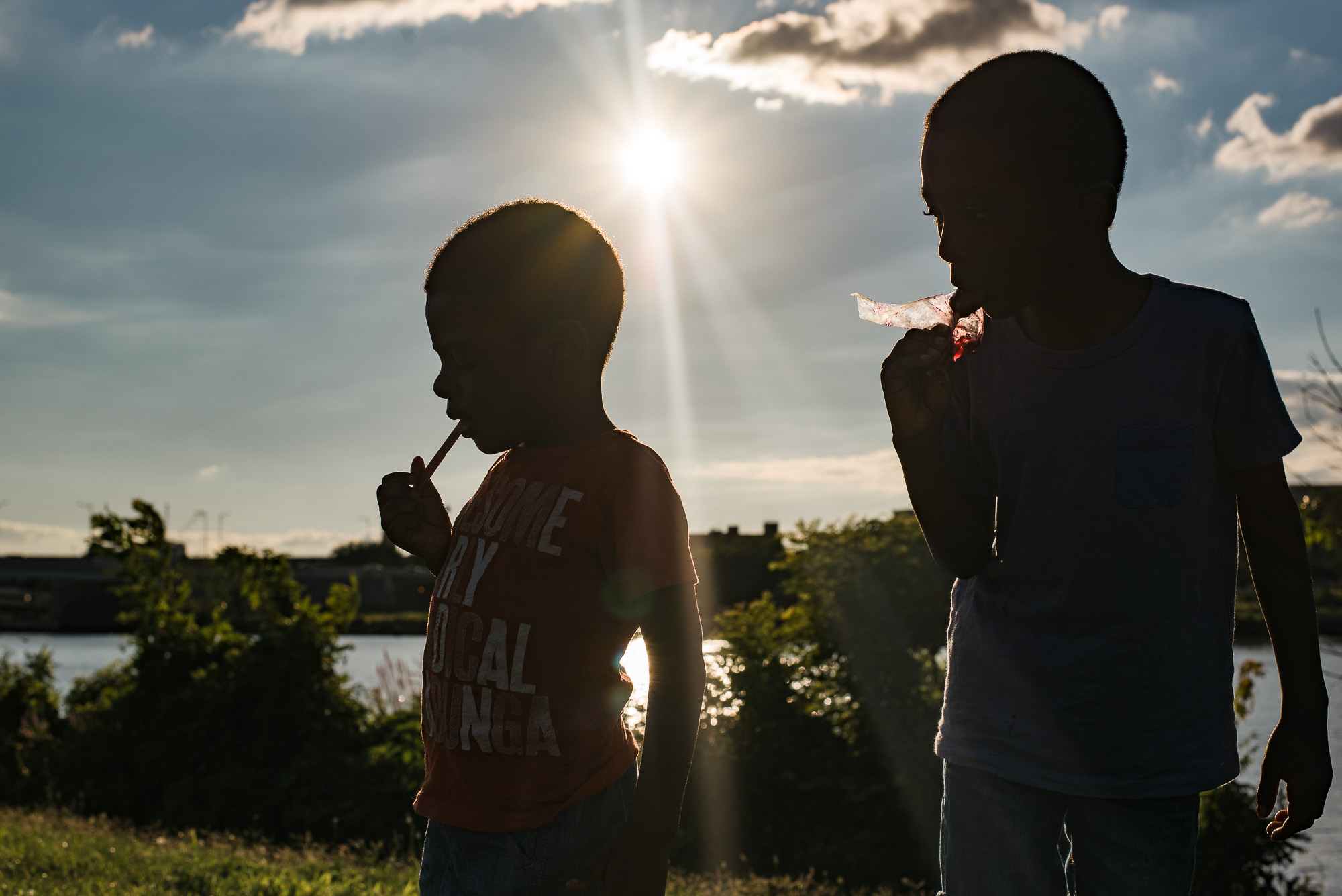 silhouette of kids near lake - documentary family photography