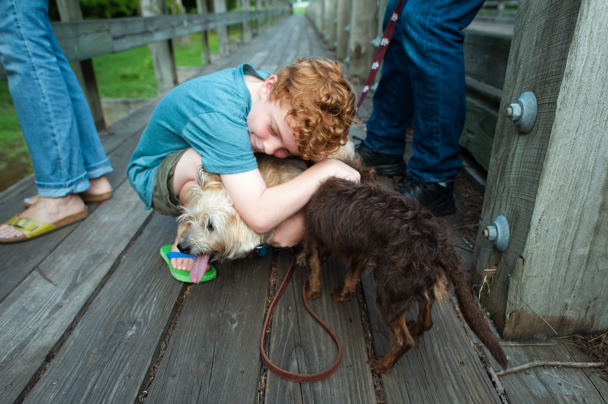 boy hugs dog - documentary family photography