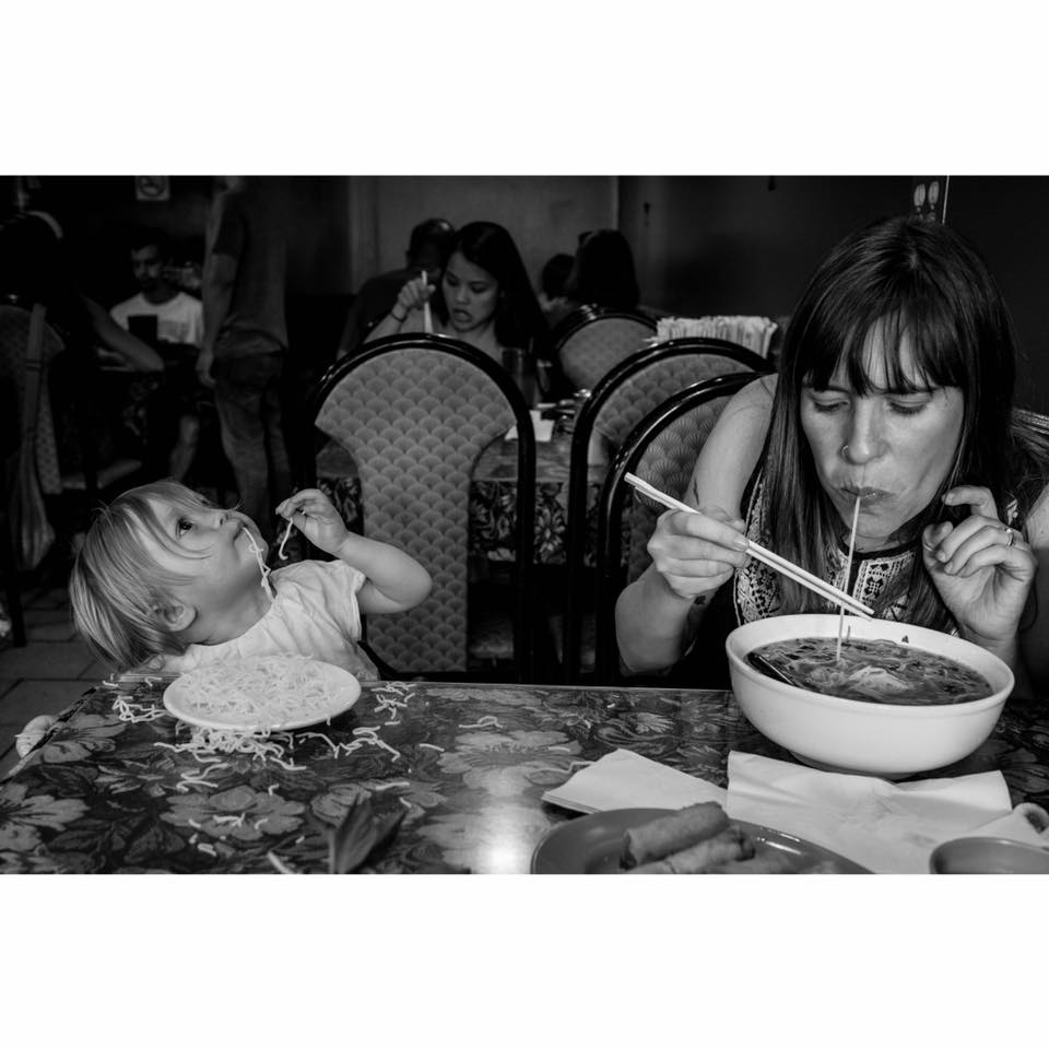 mother and daughter eat noodles - documentary family photography