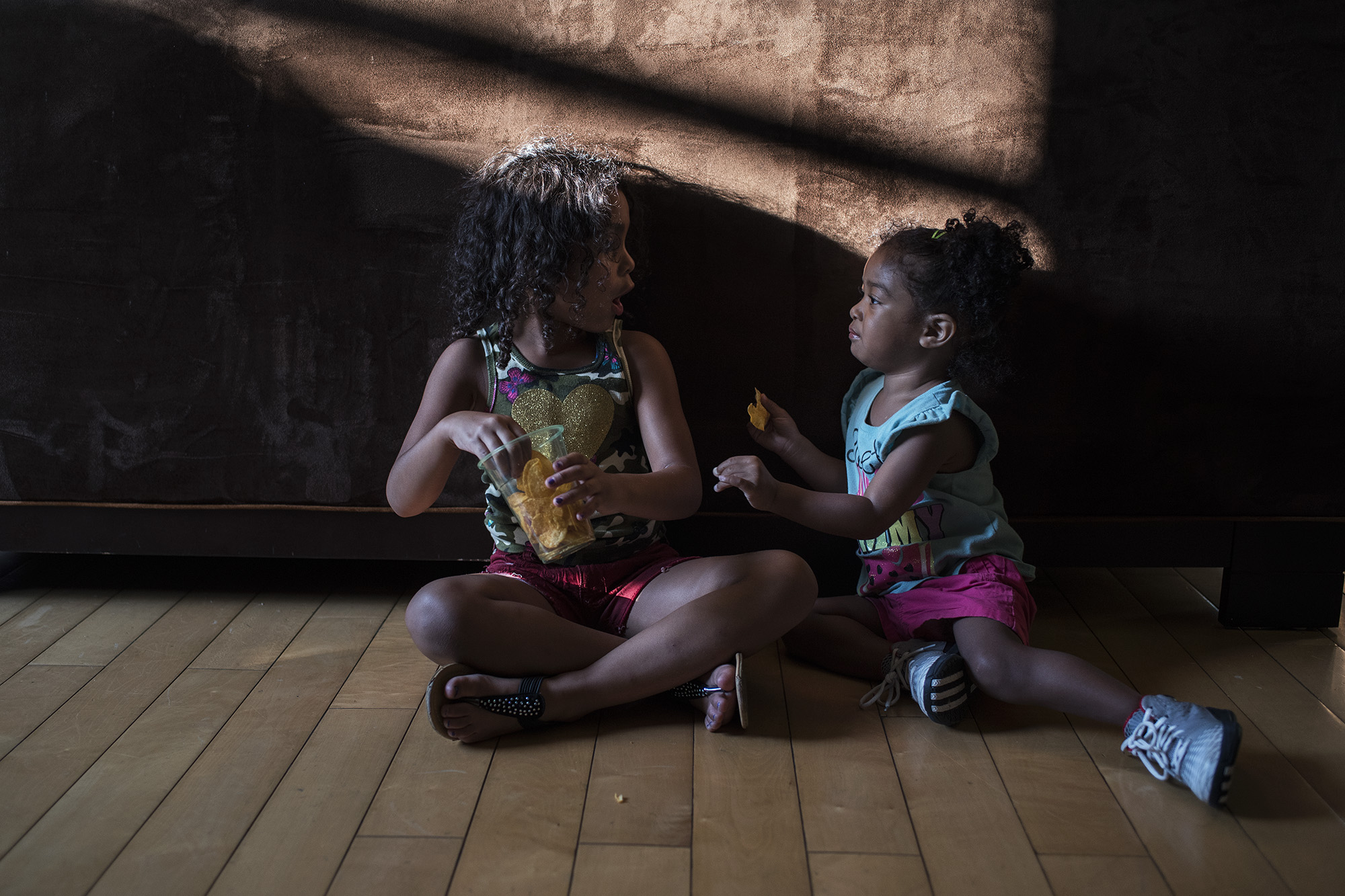 girls sitting in shadow - Documentary Family Photography