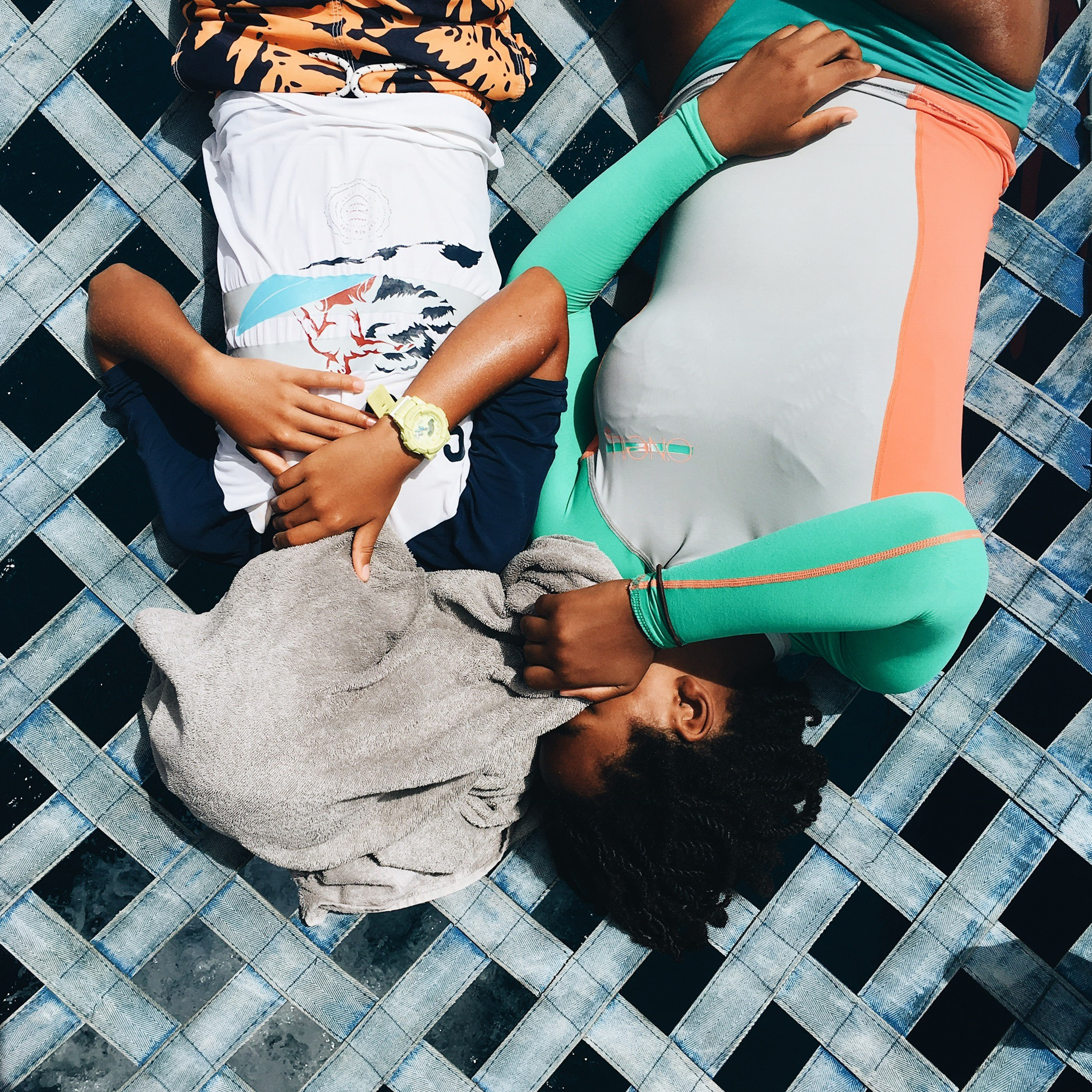 girls laying in sunshine - documentary family photography