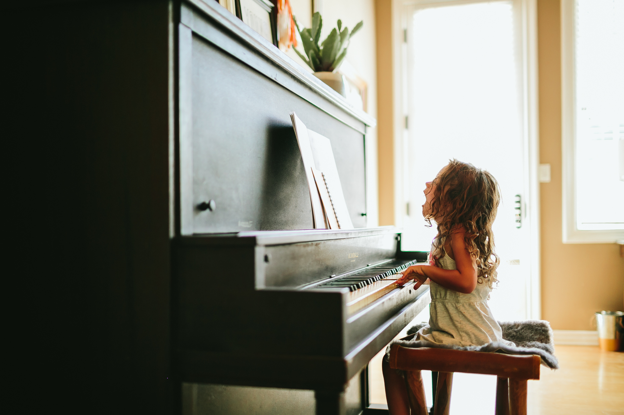 child at piano - documentary family photography