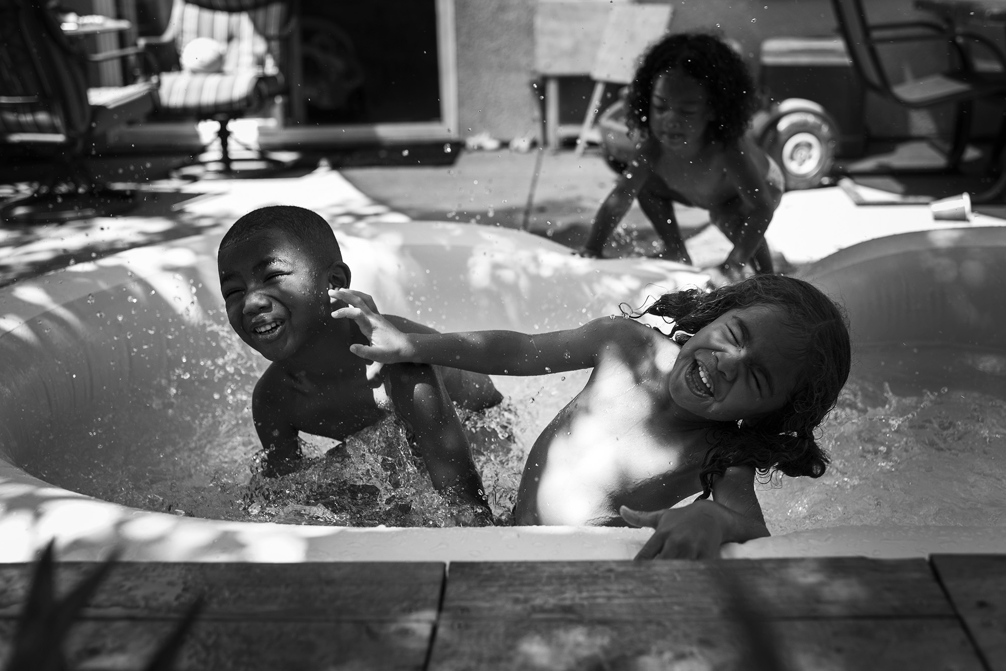 kids playing in wading pool - documentary family photography