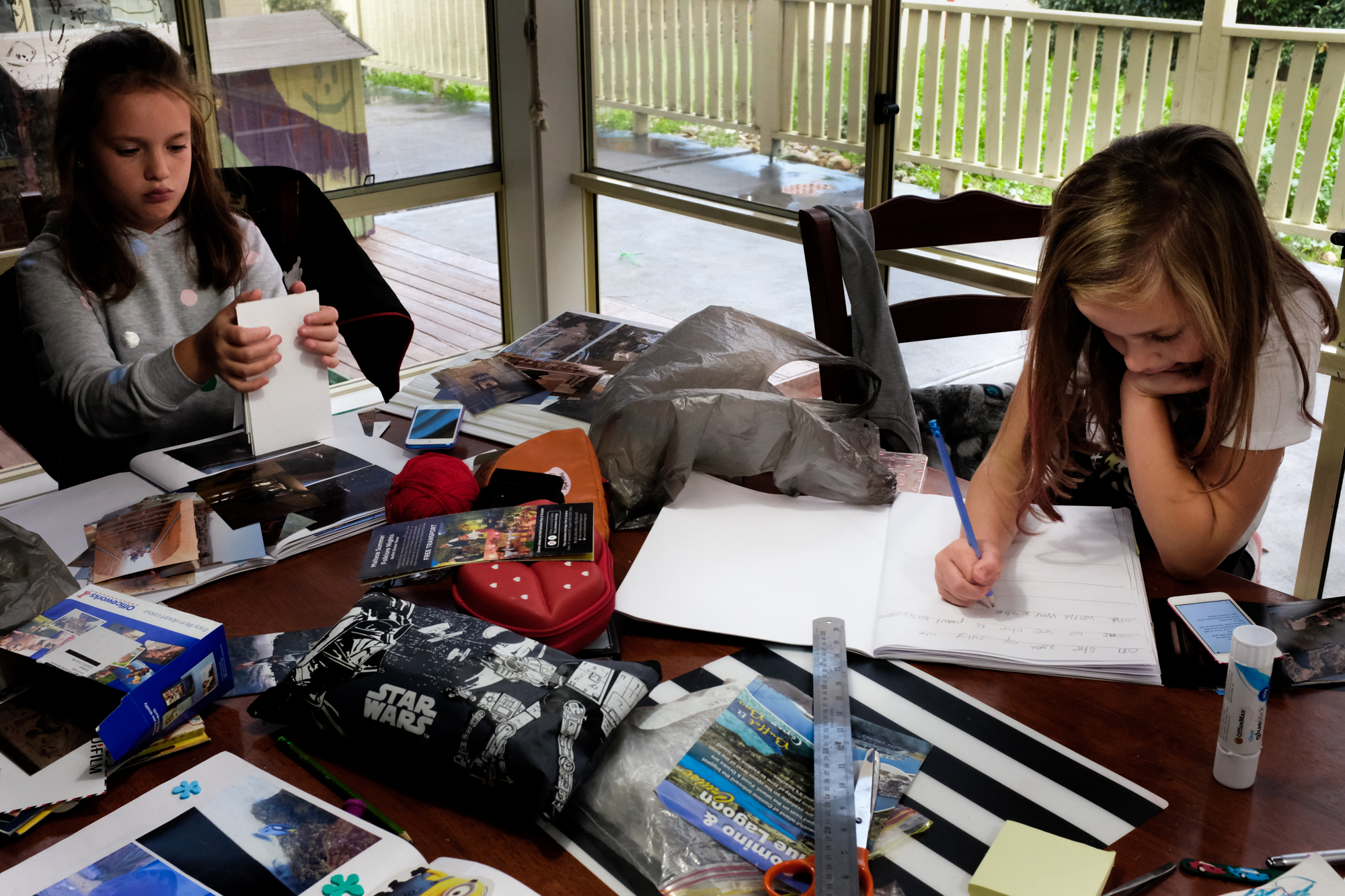 kids doing work at table - documentary family photography