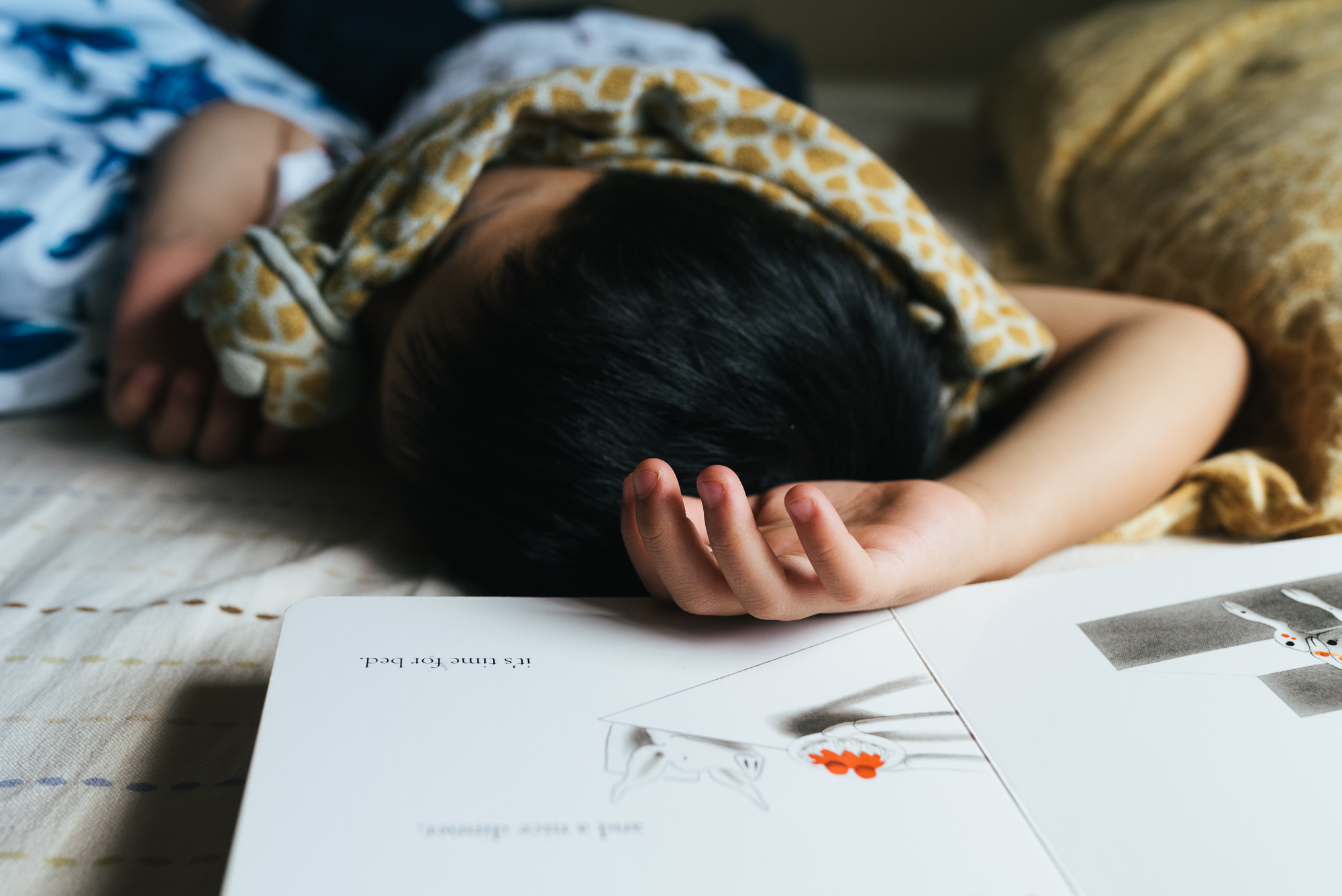 child asleep amid drawing - documentary family photography