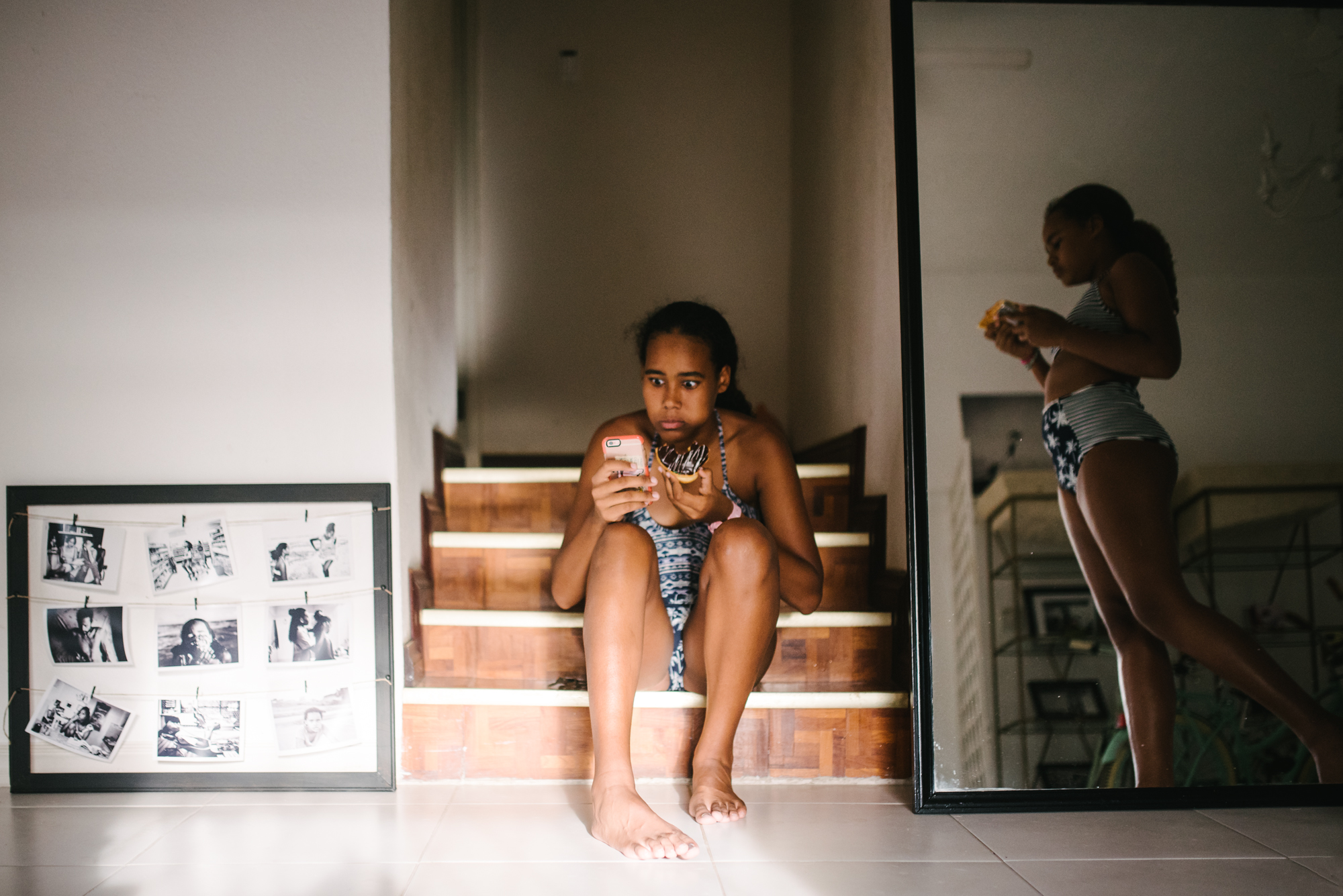 girl waits on stairs with phone - Documentary Family Photography