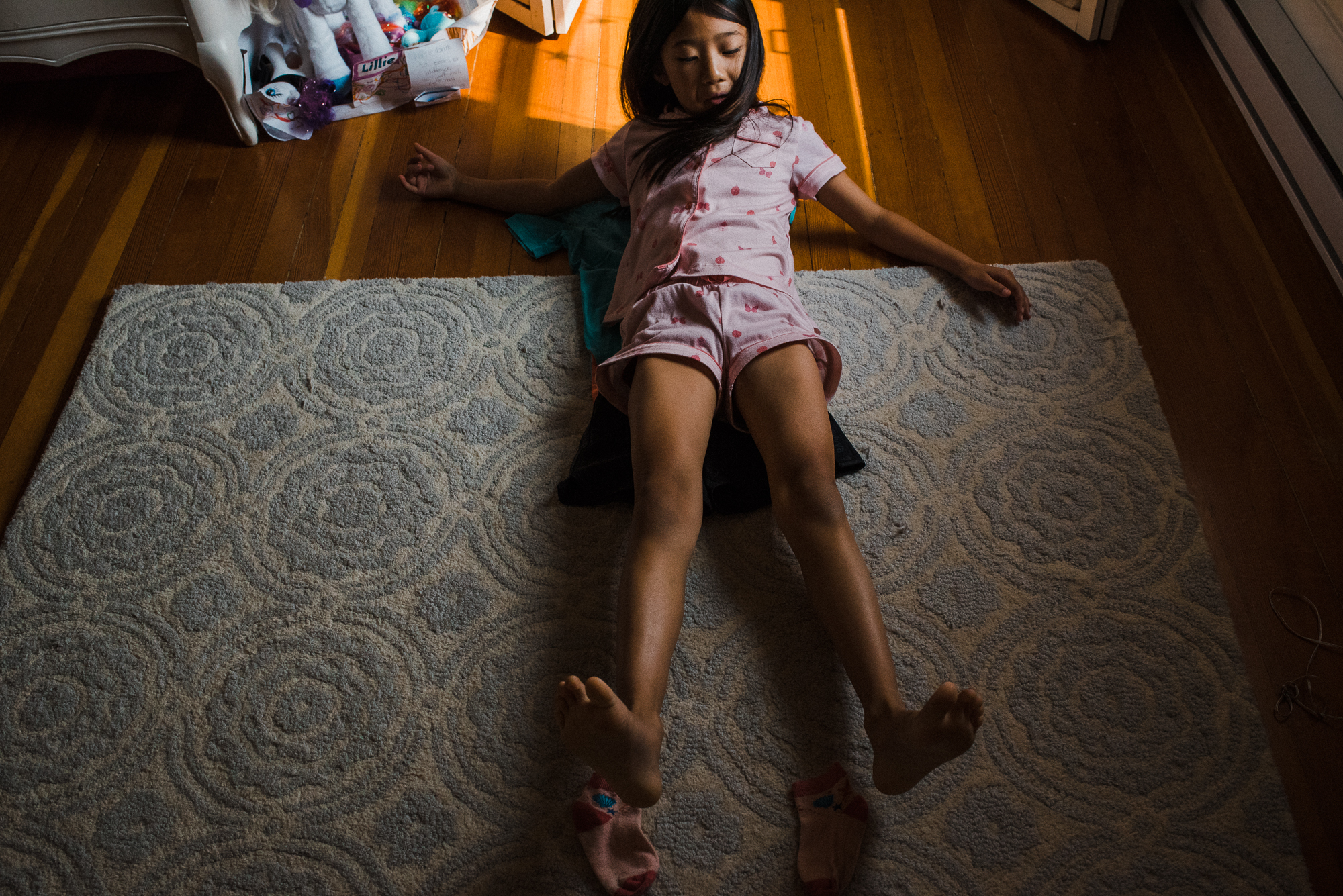 girl laying on floor - Documentary Family Photography