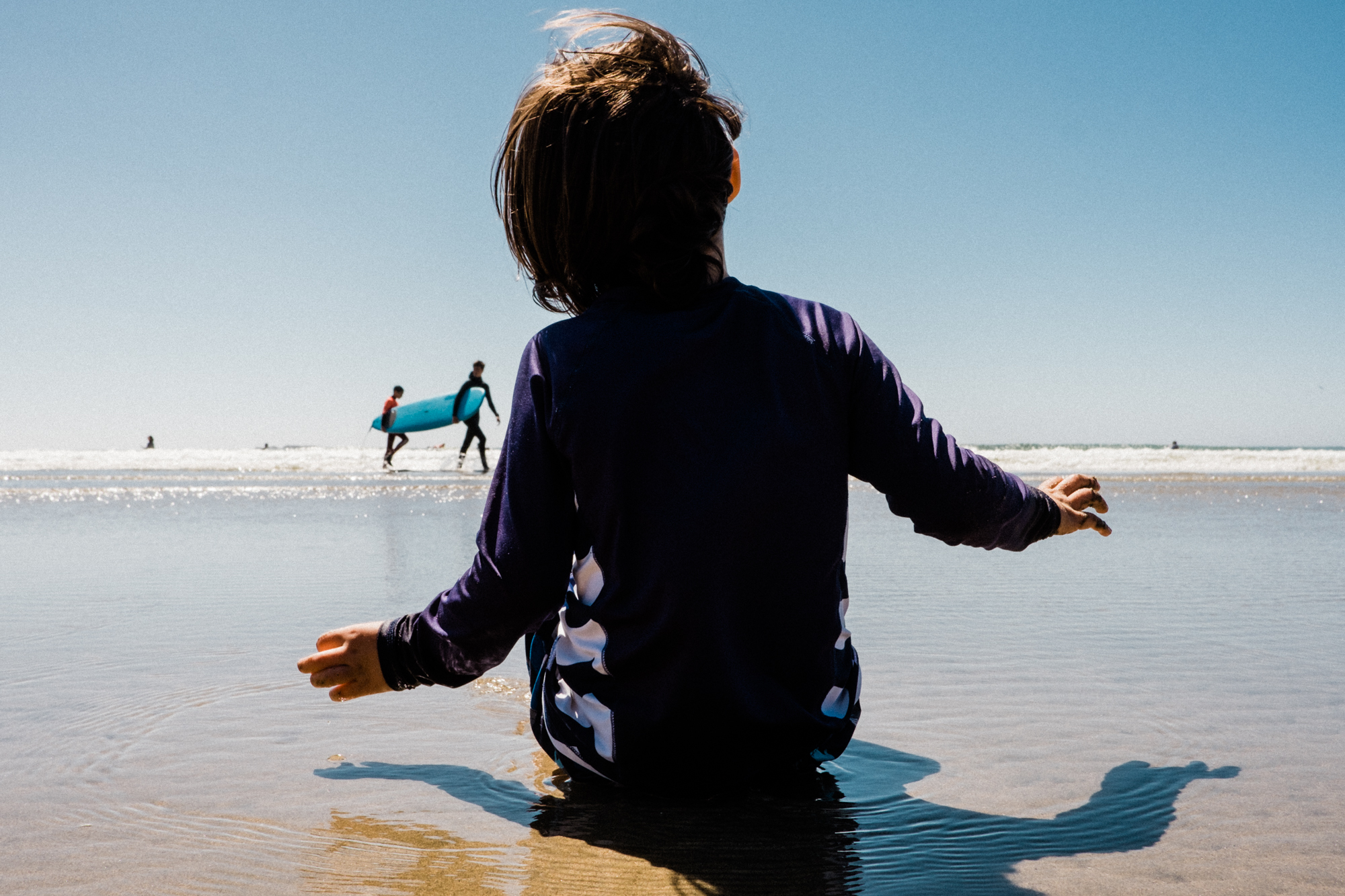 boy sitting on beach - Documentary Family Photography