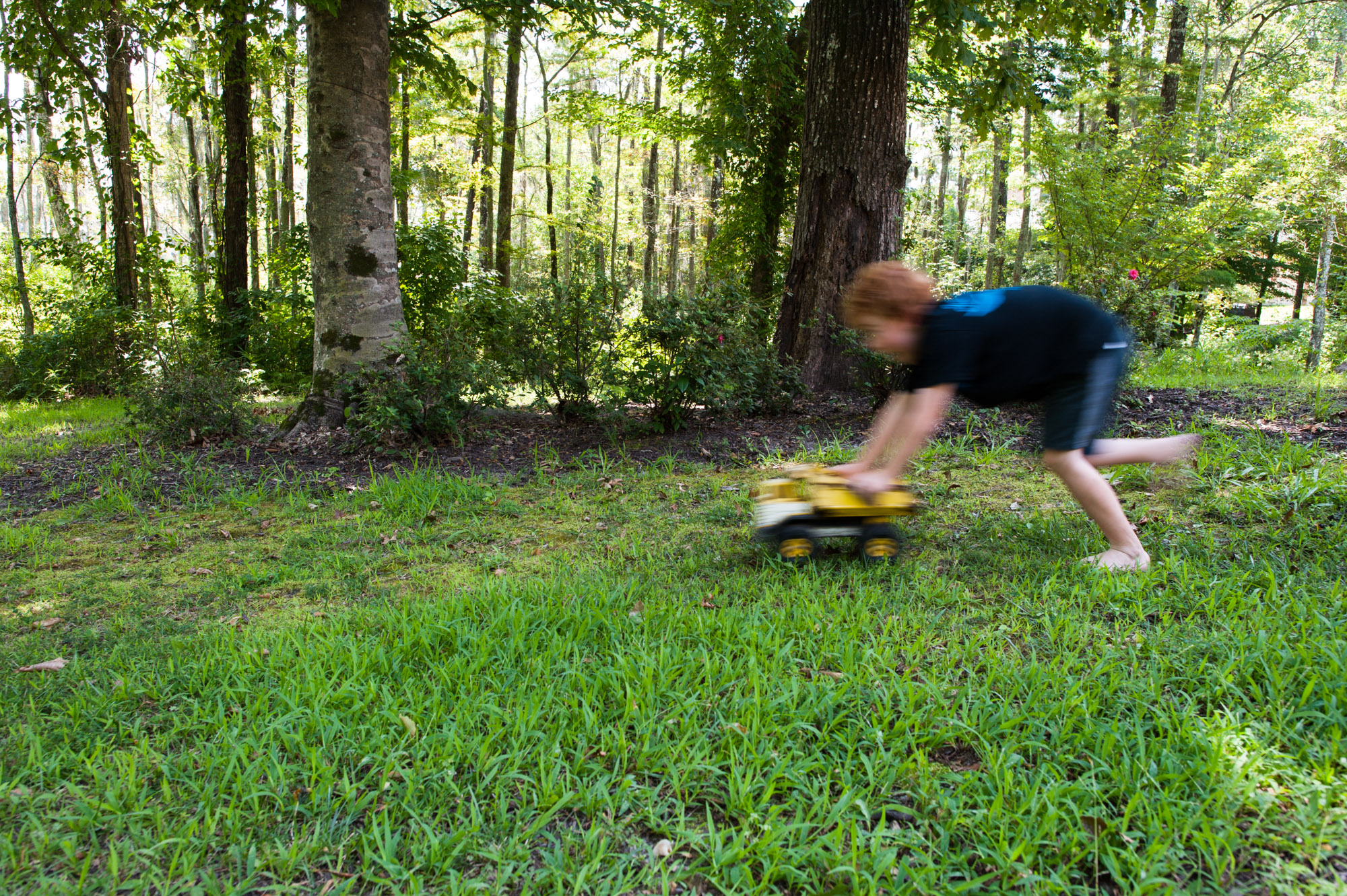 boy runs with dump truck - Documentary Family Photography