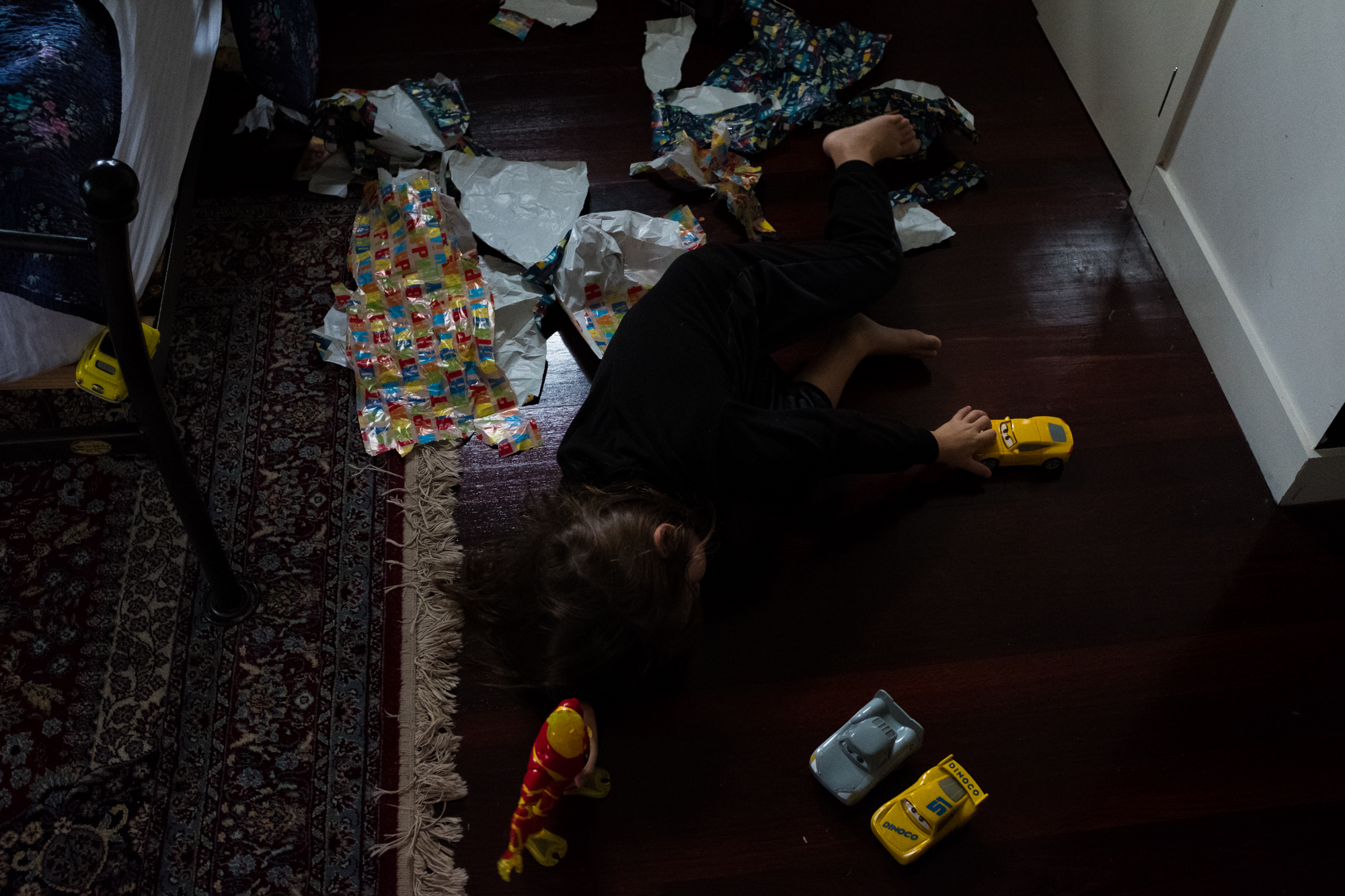 boy asleep in wrapping paper - Documentary Family Photography