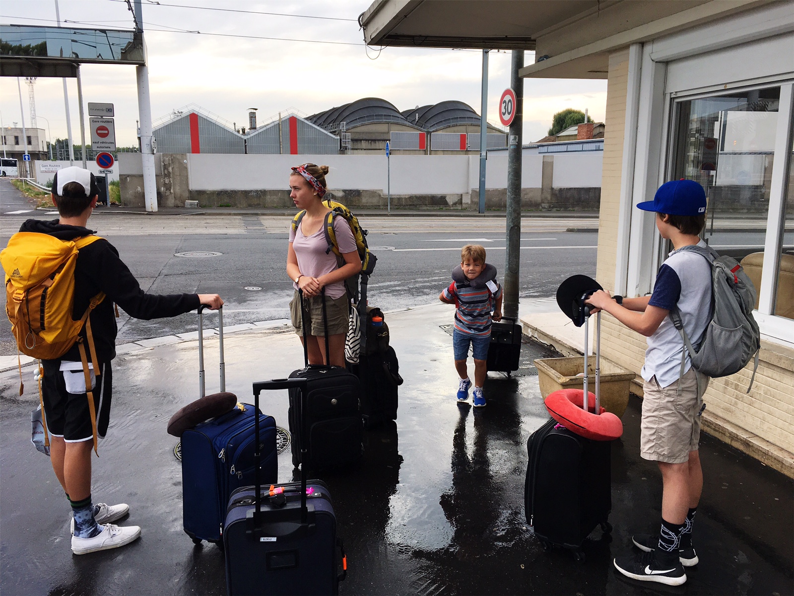 family waits with luggage - Documentary Family Photography