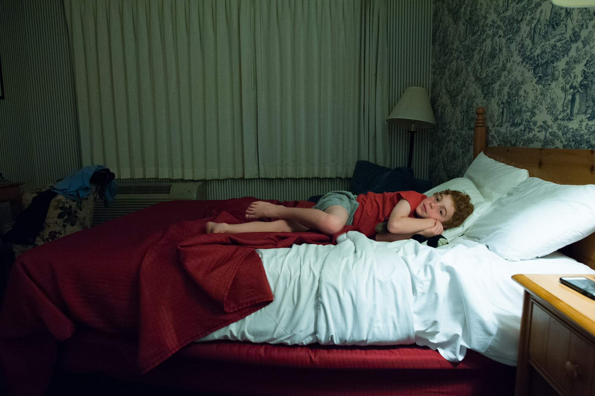 boy cuddles in bed - Documentary Family Photography