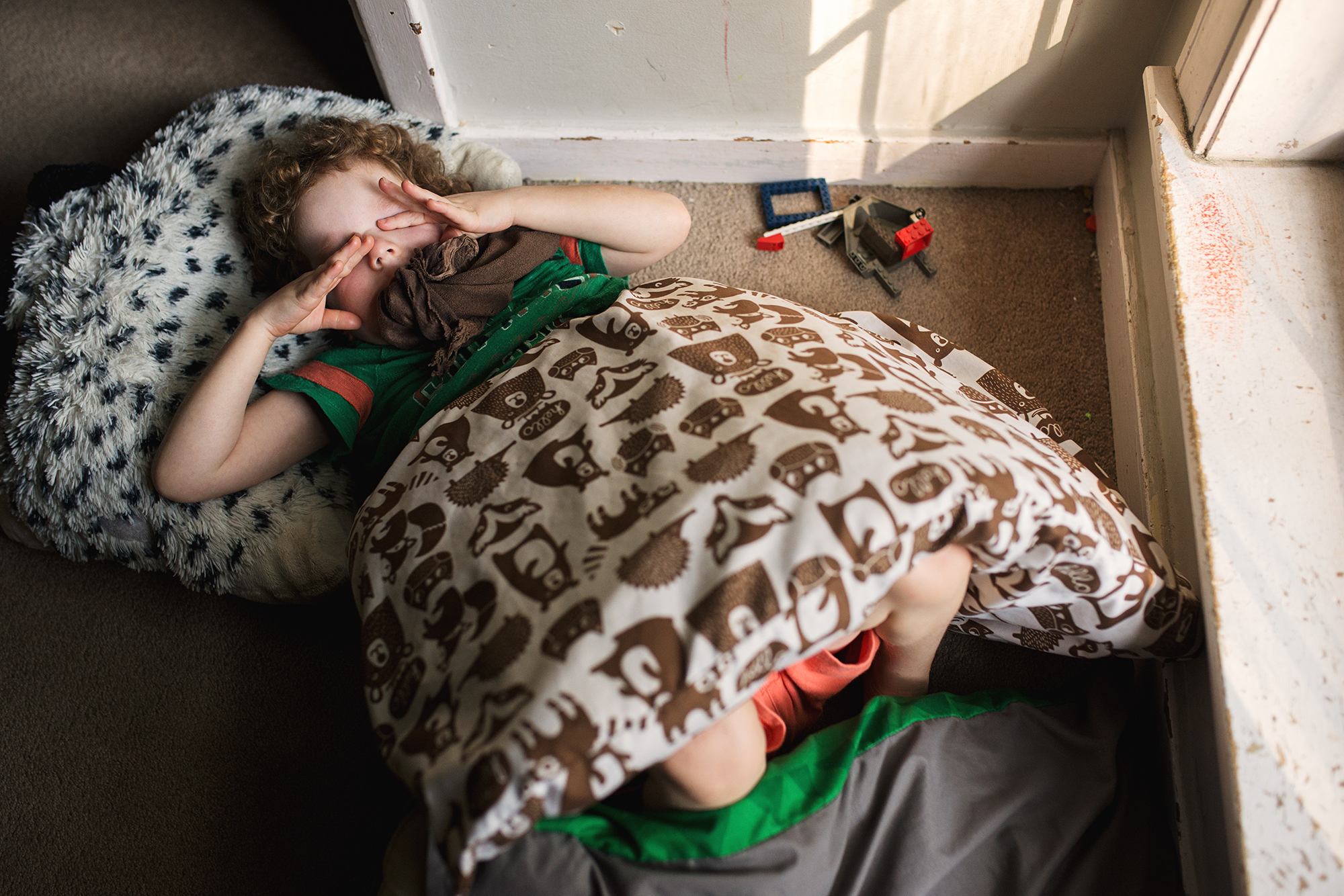 child rubs eyes after nap - Documentary Family Photography