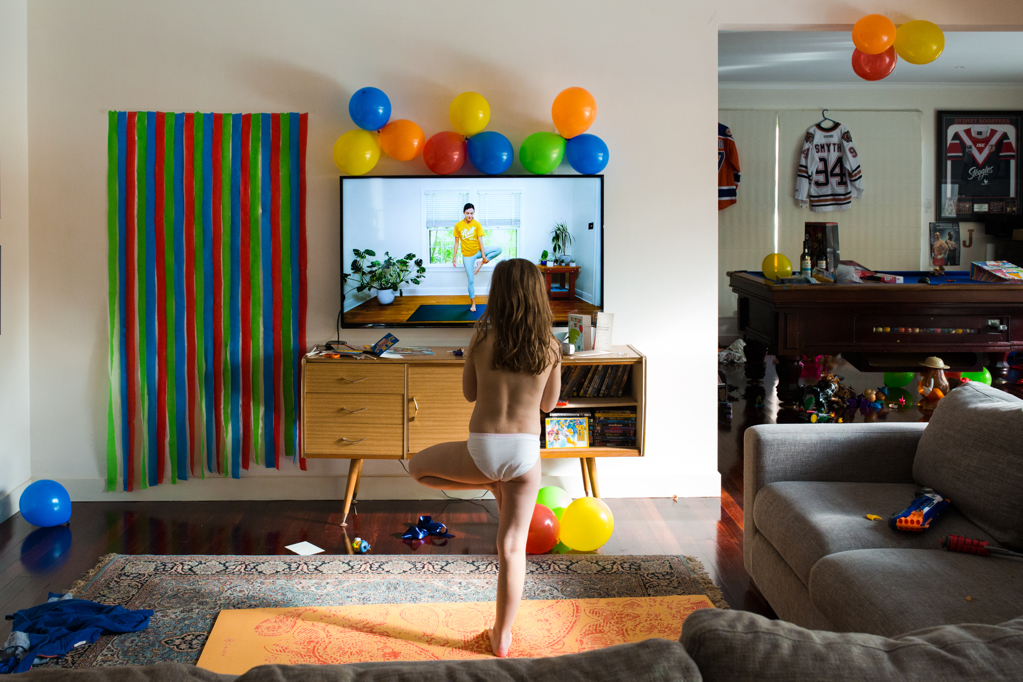 child doing yoga in living room - Documentary Family Photography