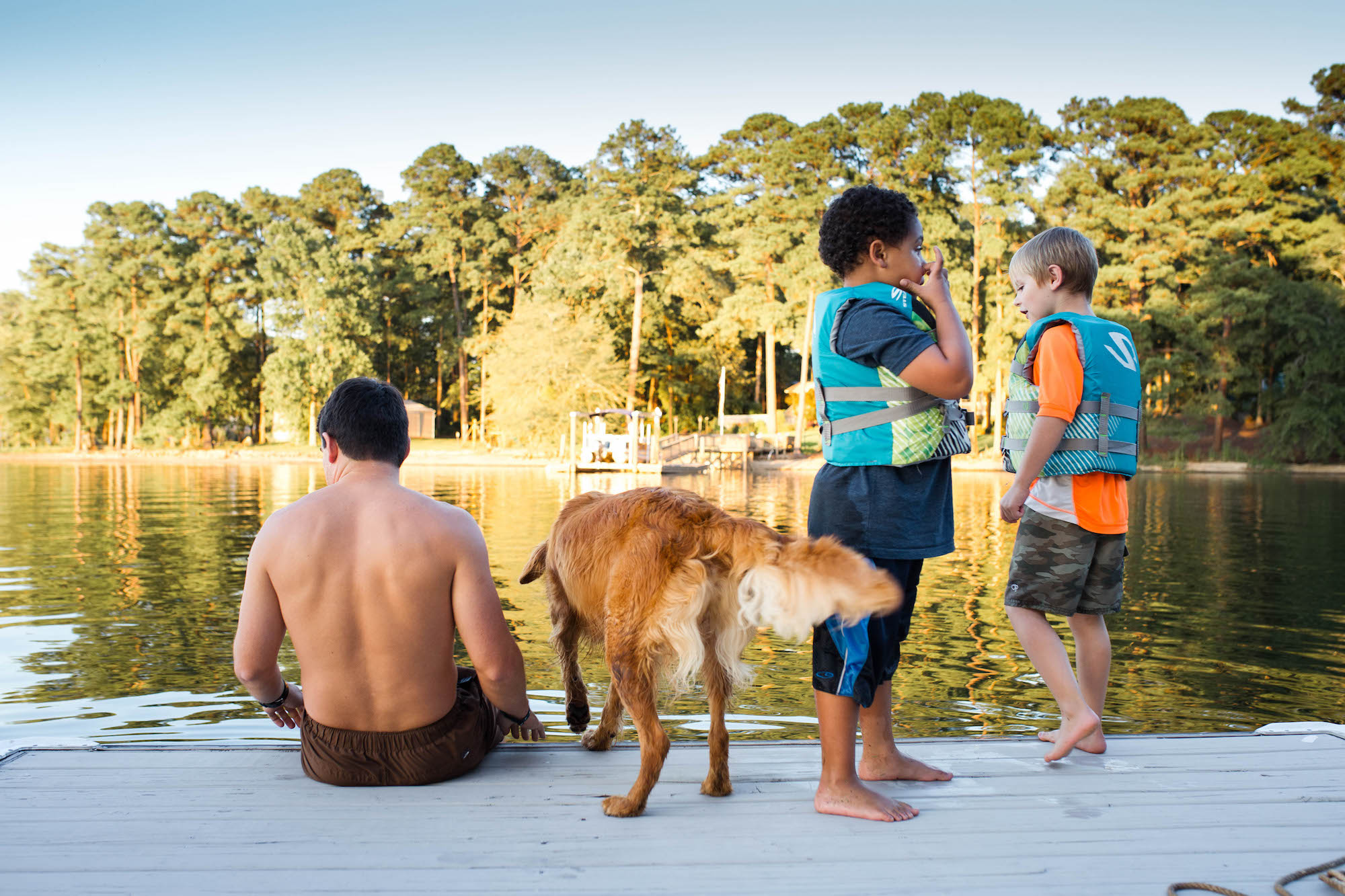 kids with dad and dog on dock - Documentary Family Photography
