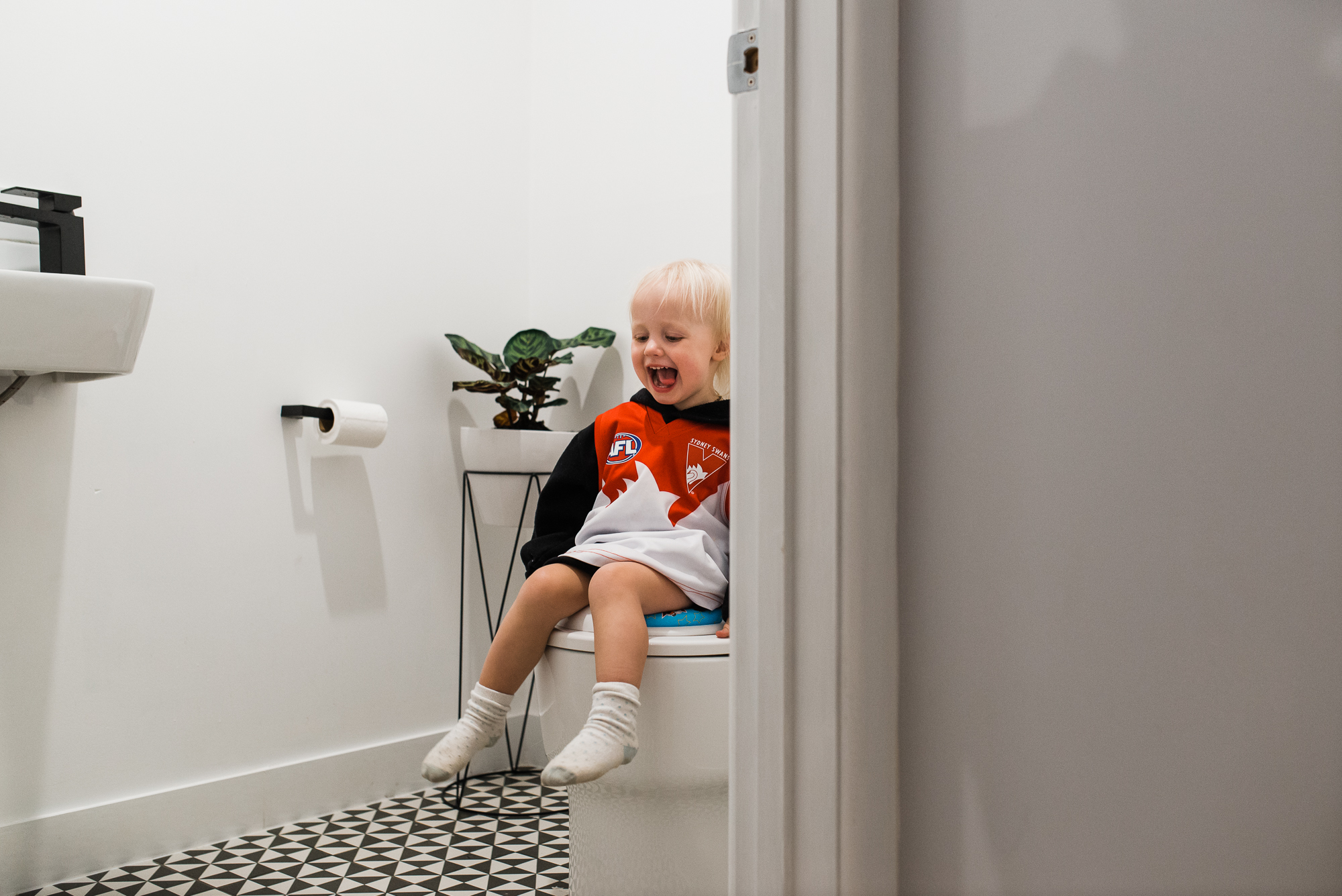 child sits on toilet and yells - Documentary Family Photography