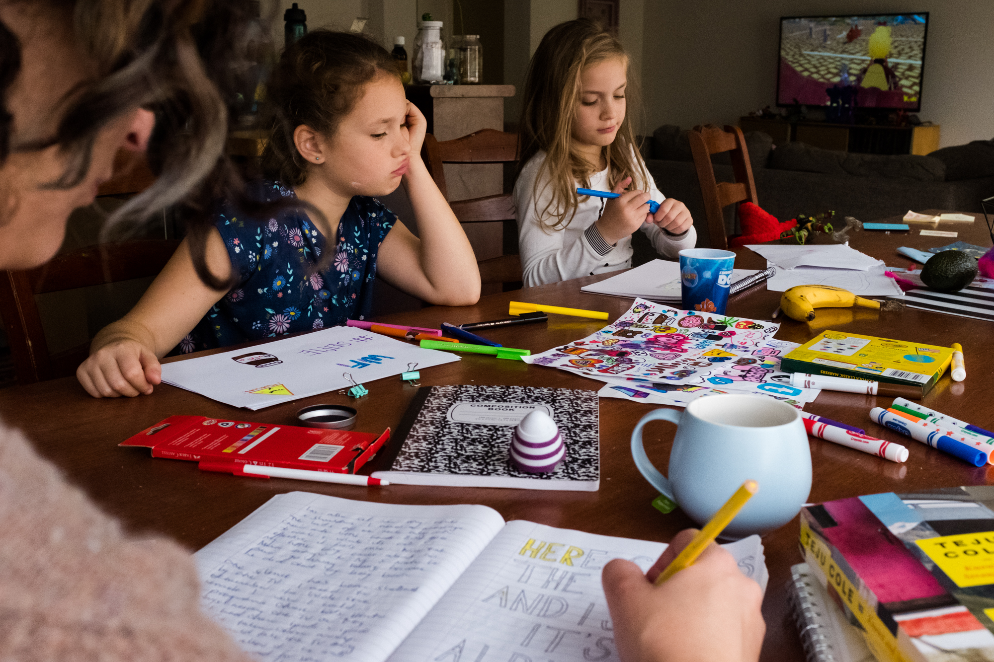 kids doing homework at kitchen table - Documentary Family Photography