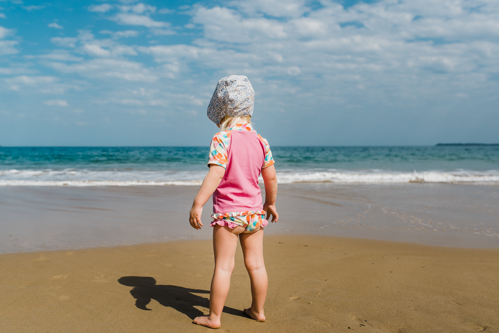 girl stands alone on beach -Documentary Family Photography