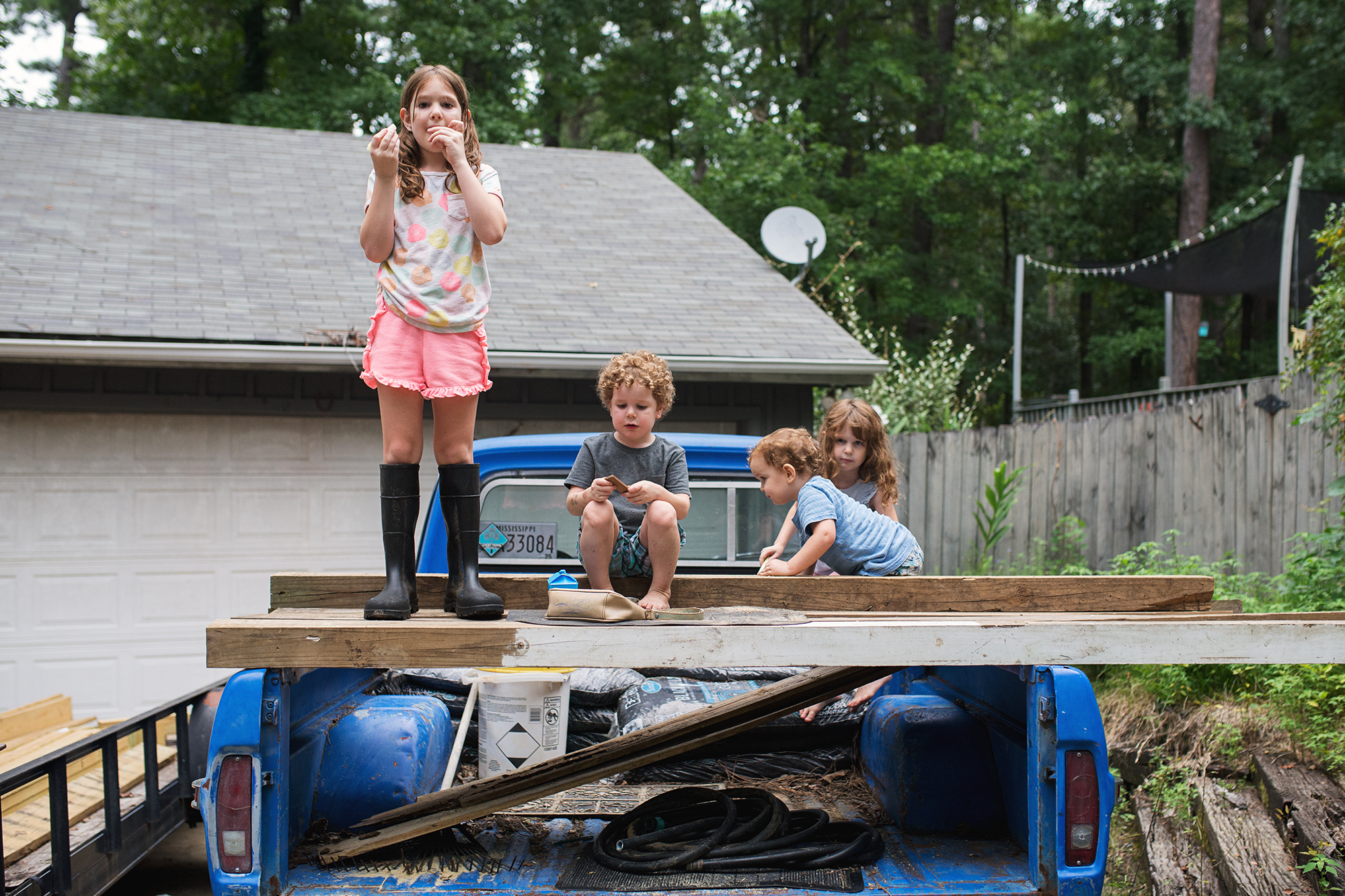 kids climb on truck bed - Documentary Family Photography