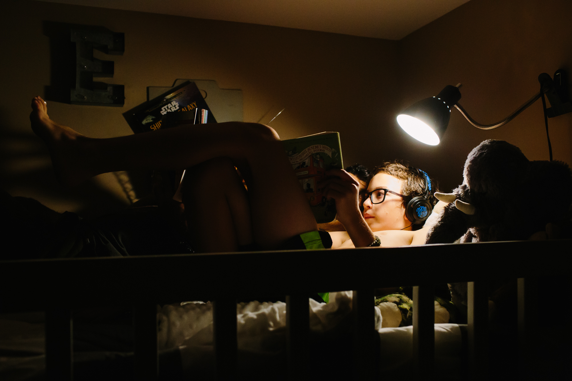 child reads in bed - Documentary Family Photography