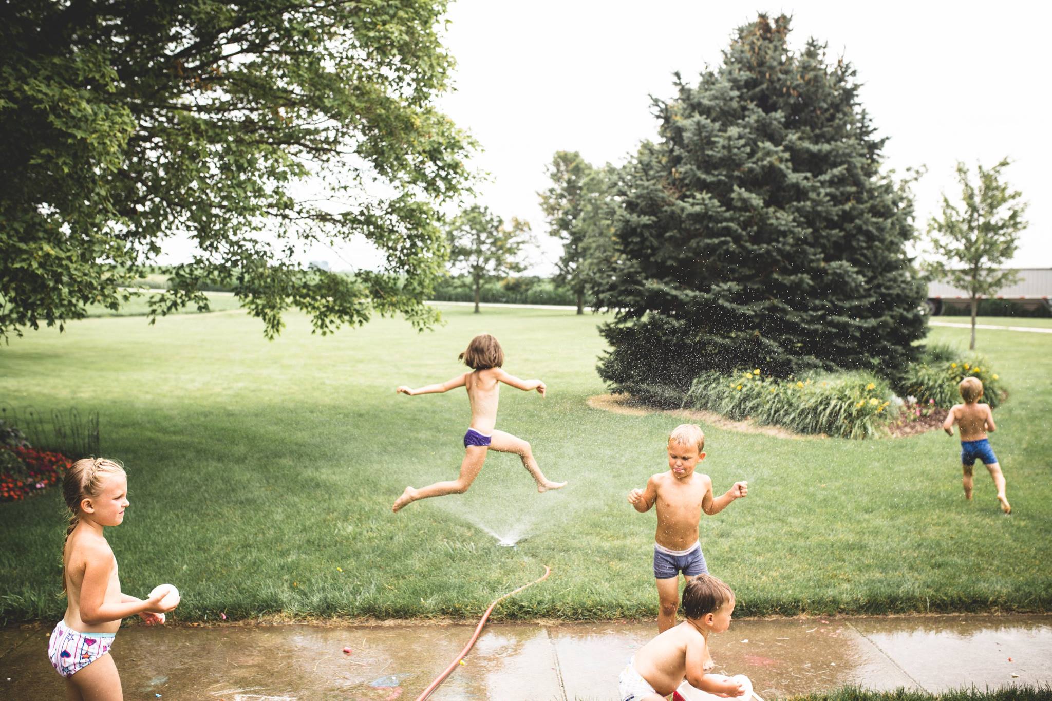 kids run through sprinkler - Documentary Family Photography