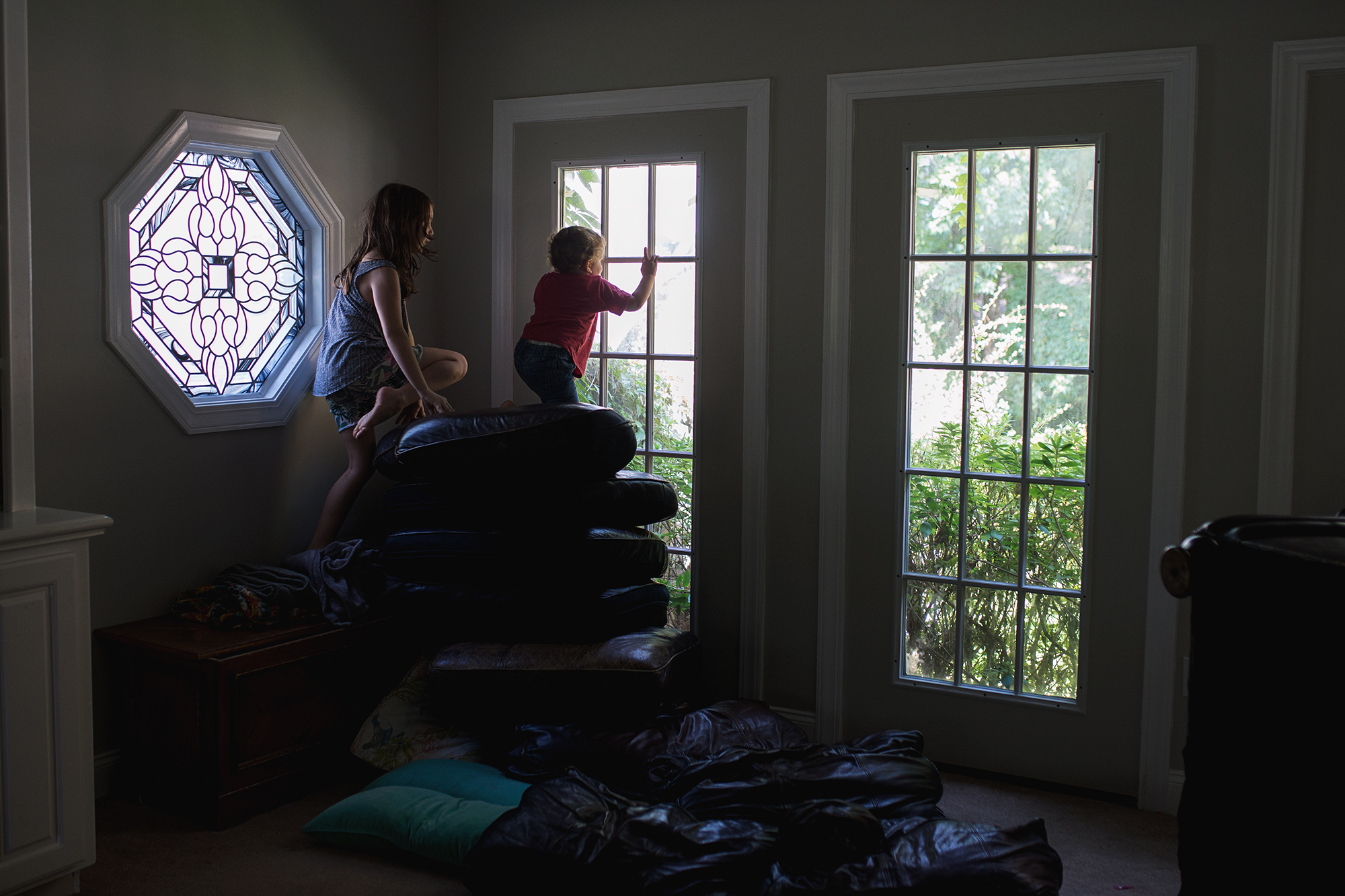 Kids looking out french door windows - Documentary Family Photography