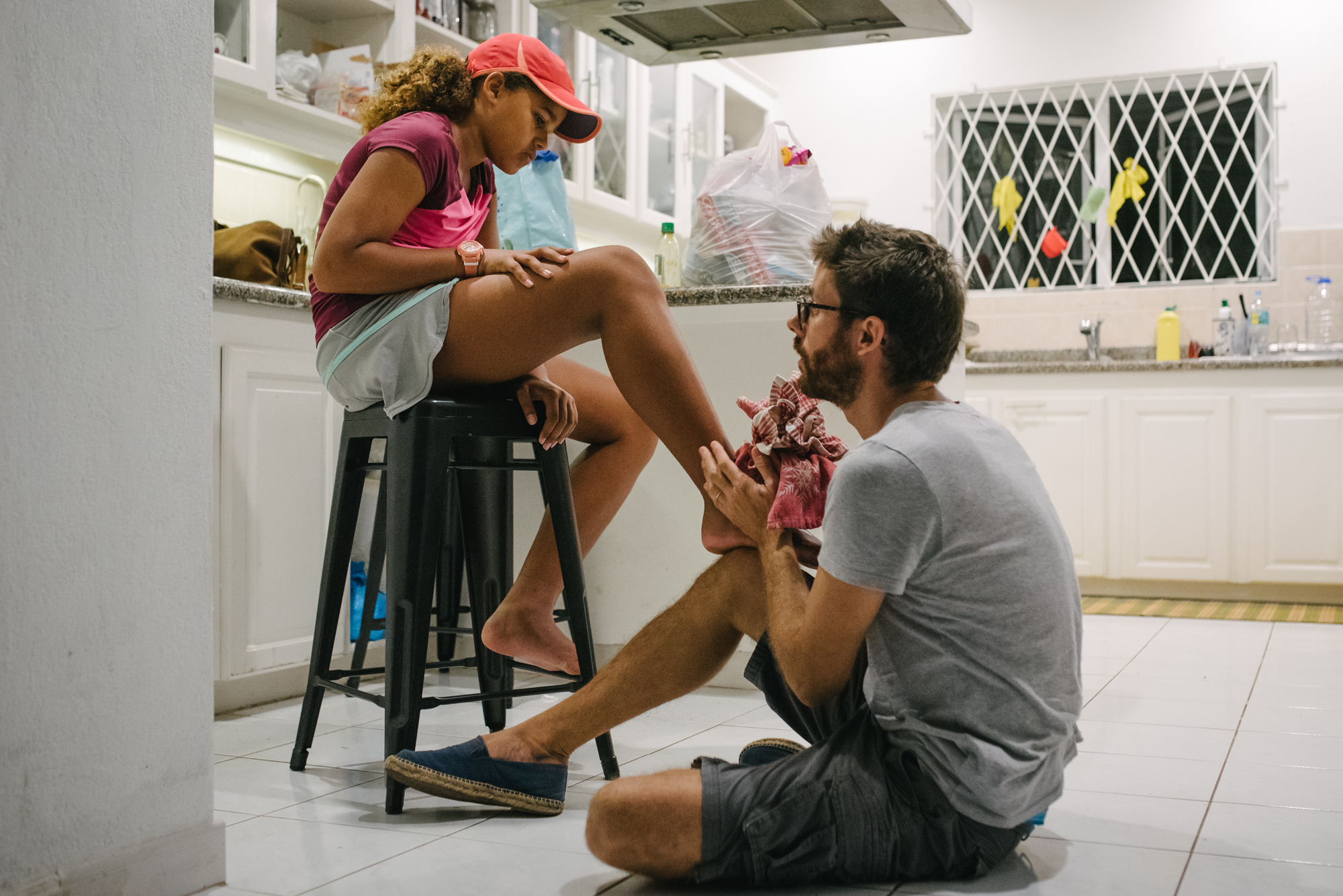 father looks at girls foot - Documentary Family Photography