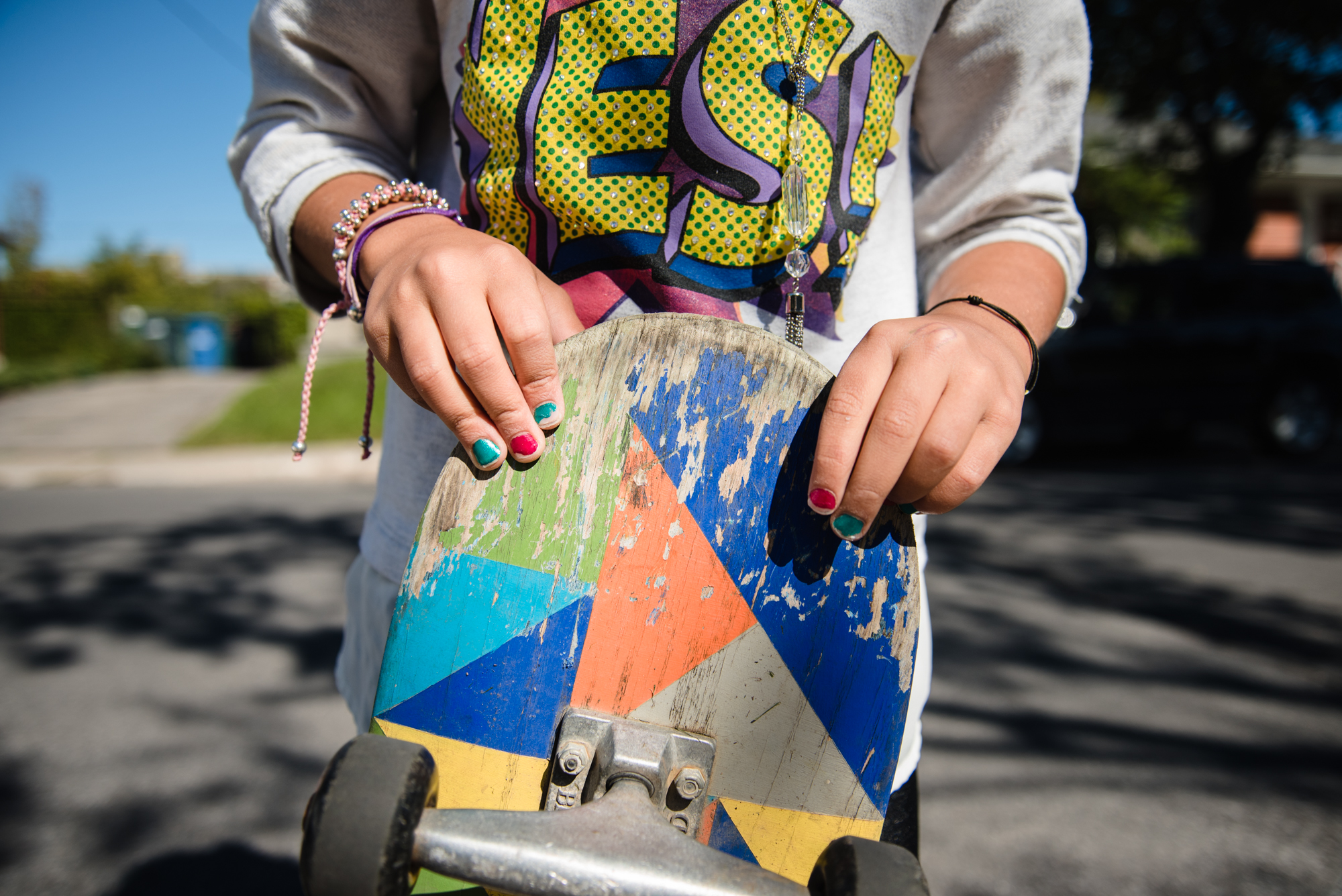 child holding dirty skateboard - Documentary Family Photography