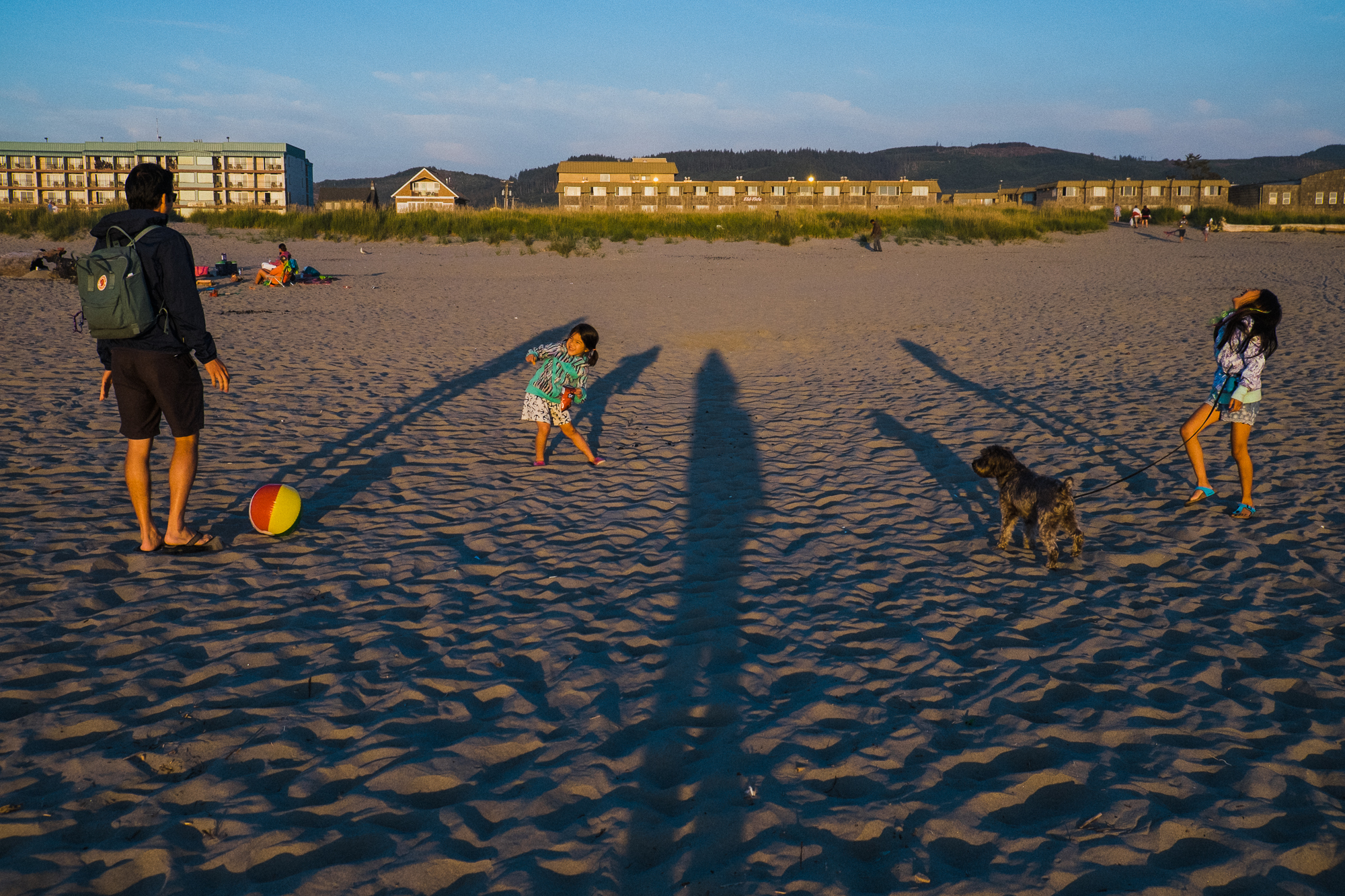 family with long shadows on beach - Documentary Family Photography