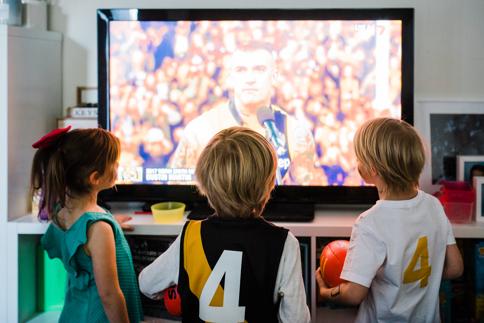 kids watching sports on TV - Documentary Family Photography