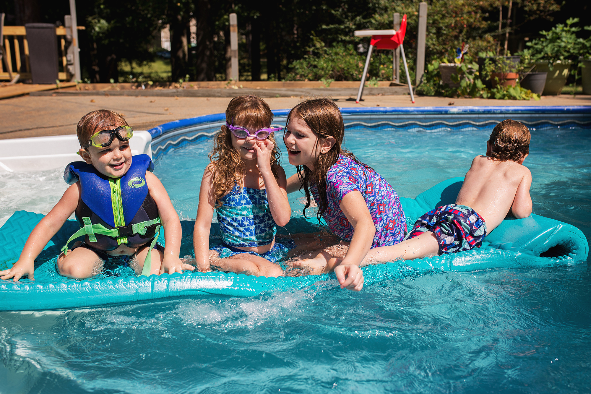 kids on float in pool - documentary family photography